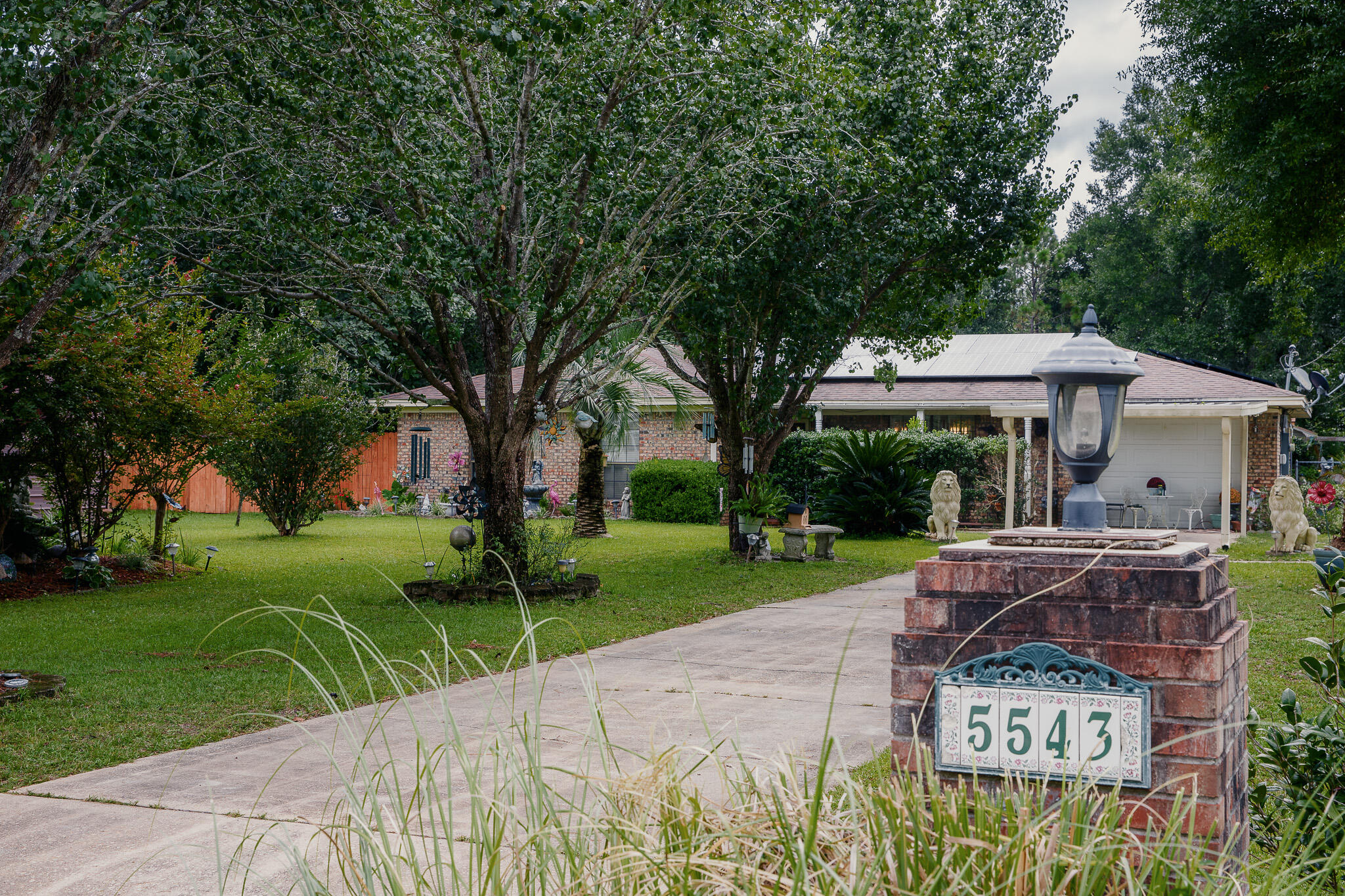 All Brick 3 Bedroom Southern Charmer in Grandview Estates! Paid-off solar panels valued at $55,000 for energy savings! Step through the front door into a bright living room with crown molding, tiled floors and rustic paneling. Next, flow right into the updated galley style kitchen that features white cabinets, fresh countertops, and newer stainless steel appliances--plus an eat-in dining area for family meals. A bonus family room/den offers extra space for relaxing or entertaining. Down the hall, you'll find the bedrooms tucked away for privacy. The primary suite is perfect for relaxing with an ensuite bathroom that boasts a new vanity, walk in closet and more. Down the hall you will find your 2 guest bedrooms with ample room for larger furniture and a guest bathroom with new vanity. Set on a 1/2 an acre lush, maturely landscaped yard with a full irrigation system and a new water well, this property offers incredible outdoor living! Multiple storage sheds, greenhouse, a carport, and a custom-built gazebo/pavilion with an entertainment center make this a true entertainer's dream! Grill, chill, watch the big game, and relax with family as the sun sets. A Canadian-built 16ft bandsaw/sawmill is negotiable for hobbyists or woodworkers.
Don't forget this place is loaded with charm and whimsical updates around the yard! Call today for your private showing!