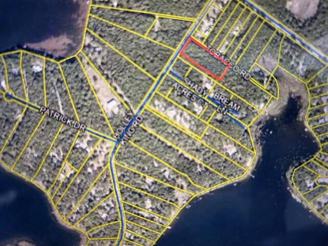 Two Acre wooded lot in tranquil lake community.