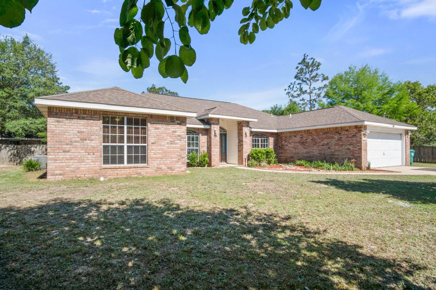 Here is your RARE Opportunity to own an upgraded and well maintained 4 bed/2bath/2 car garage home with a pool, detached mother-in-law suite, South of I-10, on a flat acre lot, and with low county taxes! The home welcomes family and guests alike an open concept foyer, oversized family room anchored with a fireplace, and kitchen. The home has a freshly painted interior in ''agreeable gray'' with wood look tile throughout main living area and master suite, and brand new carpet in the additional bedrooms. The kitchen has been updated with new cabinets with ample storage and counter space, granite countertops, stainless steel appliance package, and an island with kitchen sink for easy meal prep. The master suite features tiled flooring, updated dual vanities, separate garden tub, beautiful tiled shower with river rock floor and frame-less shower door.  The home also has a formal dining room and office located just of the entry to the home.  The additional bedrooms are nice sized with ample closet space.  There is a screened Florida room off the back of the home overlooking the vinyl lined in ground pool.  The detached 575 sqft heated and cooled 1bed/1bath mother-in-aw suite with a living room, efficiency style kitchen (without stove) and includes a washer and dryer.  There is an additional garage and separate store building on the property as well.  The home sits towards the front of the property with a large cleared backyard with endless possibilites for RV/boat storage and workshop etc! Schedule your appointment today!