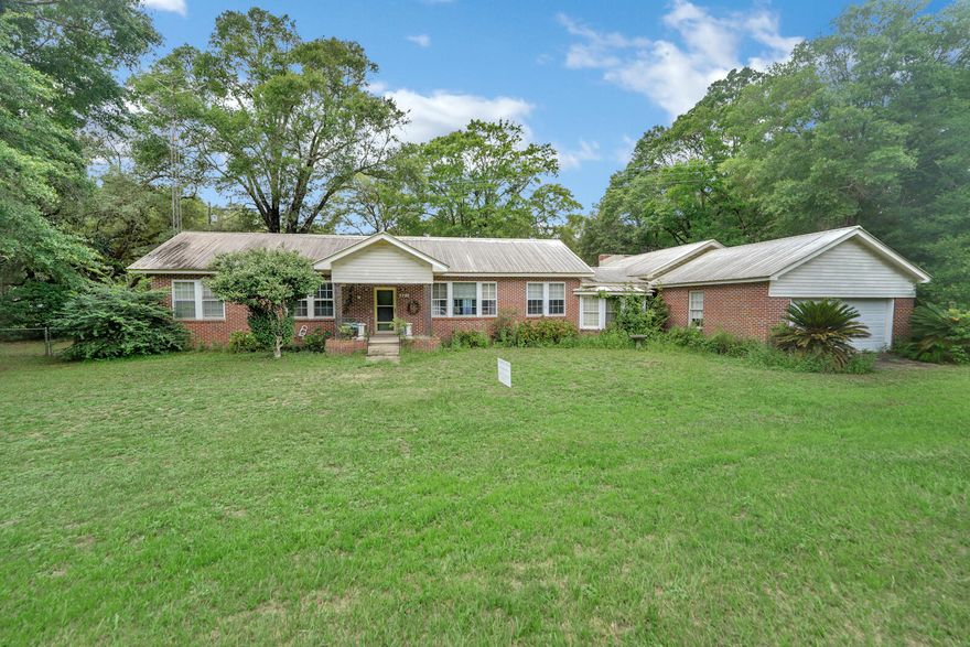 ENDLESS POTENTIAL!  Situated just 30 miles N of Gulf of Mexico in Walton County-this 4 bedroom 3 full bath brick ranch sits on 2.64 acres . It boasts 2 Master suites. One includes  large walk in handicap shower.Also included is a spacious bonus room that could be used as a 5th bedroom. this home has room for large families. Detached 2 car garage with attached wood shop includes electric. Lg greenhouse with chicken coop inside includes electric and water.There is also potential for 2 bedroom guest house .with separate electric meter/water( ). You have options of Freeport or Defuniak school system through bus pickup on corner of Rockhill and South Tram.