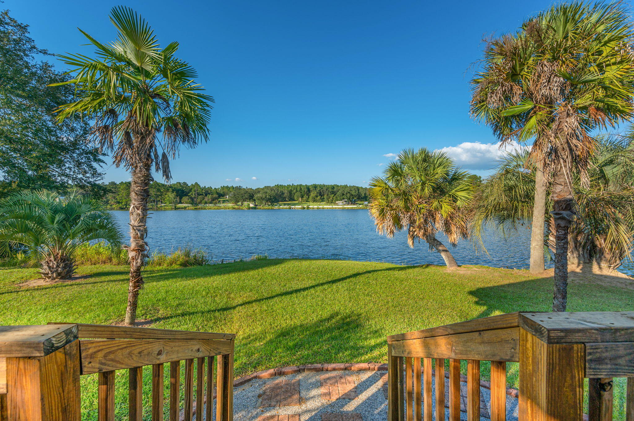 DUE TO MULTIPLE OFFERS RECEIVED, HIGHEST AND BEST OFFERS WILL BE DUE TO LISTING AGENT NO LATER THAN 10/12 AT 12 PM NOON. 'LET GO TO THE LAKE HOUSE!' Check out this stunning property w/ approx 500' of water frontage located on a large beautiful lake in Baker. The grounds and views of this property are simply amazing! Sip your morning coffee from your covered deck and watch the sun rise. A private entry from the main road is closed off by fencing and a gate. The ranch style home sits a good distance from the road and has undergone numerous renovations. The eat-in kitchen boasts beautiful updated cabinetry w/ granite countertops equipped w/ all the appliances. Living room is spacious and features a fireplace. Plantation shutters are located in the living room/kitchen. A large bathroom/guest