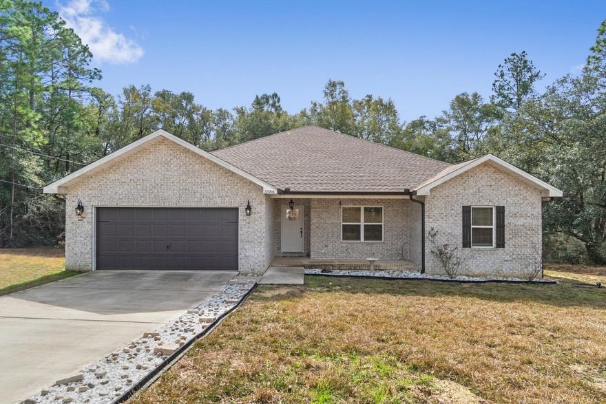 Welcome home to this practically brand new 4 bedroom/2 bath beauty on 1.20 acres with no HOA! Built in 2019 this stunning home boasts a fully updated and spacious split bedroom floor plan with 2,451 sqft. Pull into the long driveway and appreciate this tucked away retreat. The covered front porch welcomes you in, and inside you'll love the wood look tile extending throughout (carpet is only in two of the four bedrooms) and the tall ceilings. The massive living room features a trey ceiling large enough for two ceiling fans, and it features a gorgeous fireplace focus point with a wooden beam mantle and electronic fireplace (that changes colors!). Open to the show stopping kitchen you'll find white shaker cabinets with lovely hardware and soft close drawers accented with gorgeous white quartz countertops, stainless appliances, a spacious pantry, and drop down pendant lighting. The dining room space has a fantastic view of the serene backyard, and you'll find a door leading to the backyard where you'll be able to relax on your oversized back deck and enjoy the peaceful view of your property! The master bedroom is a huge space also featuring a great view of the backyard and a trey ceiling, and you'll absolutely love the ensuite bathroom! With double vanities with quartz counters, framed mirrors, and stunning lighting it gets even better when you see the soaking tub, the walk in tiled shower and the TWO walk in closets! The other three bedrooms are located on the other side of the house, and one bedroom has access to the front hallway. They all have nice sized closet space and share a full bathroom that features double vanities! The interior laundry room is also an oversized space and it leads to the two car garage. Don't delay in making this gorgeous retreat your new home!