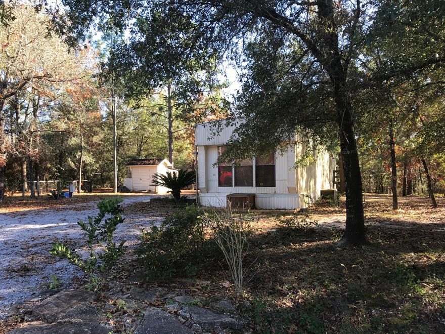 Quaint Mobile home with 2 bedrooms and 1 bathroom. Beautiful 1/4 acre lot also has a workshop, lush trees, plenty of parking and a nice deck off the front of the home. Home to be sold ''As-Is''