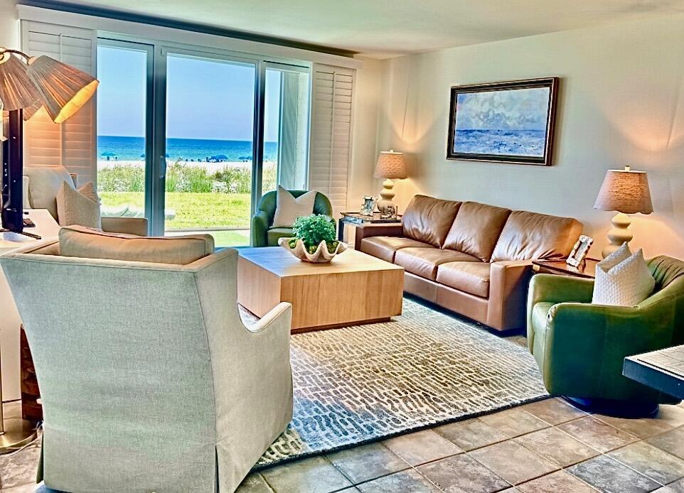 Experience a slice of paradise in this stunning ground floor condo, perfectly positioned in the heart of Destin. From the moment you arrive, you'll be greeted by unobstructed, panoramic Gulf views in the living room, kitchen and primary suite offering front door parking and a short stroll to the community pool and beautiful white sand beaches of the Gulf of America. The kitchen boasts stainless steel appliances, ample granite countertops, a large breakfast bar for casual dining, pantry and full size washer / dryer. With tile floors throughout, fresh paint, smooth ceilings (no popcorn) and fully furnished with a perfect blend of comfort and style. Step through the sliding glass door to your covered patio where you can enjoy gentle Gulf breezes and the sounds of the surf.
