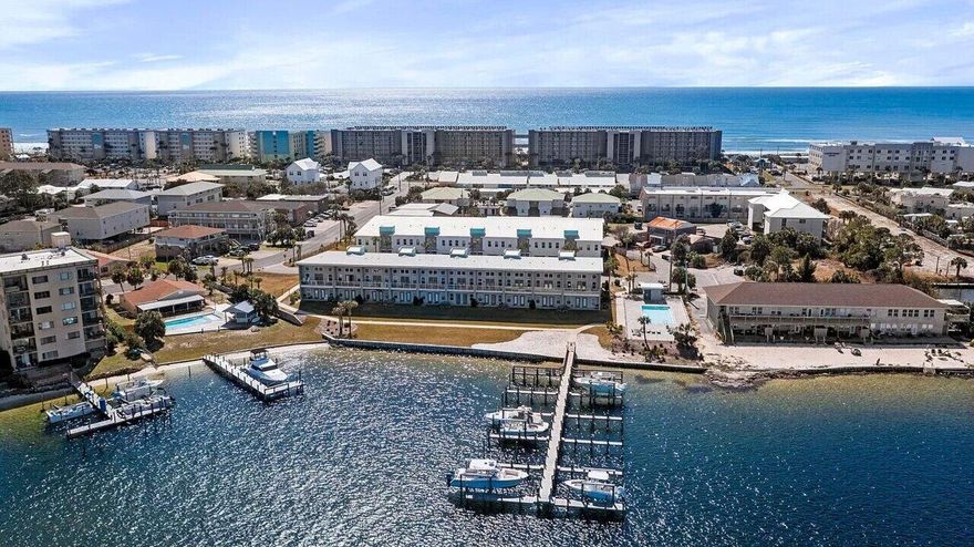 Check out this awesome immaculately kept waterfront townhome in the highly desired Soundside Lofts community on Okaloosa Island. This 3BR/3BA + bunk room home offers unobstructed Sound views and its own deep-water boat slip with a 12,000 lb lift accommodating boats up to 32 ft. Features include luxury vinyl plank flooring throughout, custom closet shelving, 5-panel doors, shaker cabinets, craftsman trim, and impact-rated windows and doors. The kitchen boasts stainless steel appliances, granite countertops, and stunning water views from both levels. Community amenities include a pool with sundeck and a private dog park. Located just a 3-5 minute walk to the white-sand beaches of the Emerald Coast and a short boat ride to Destin Harbor and Crab Island. Turn-key and ideal for a primary residence, second home, or investment property. Schedule your showing today