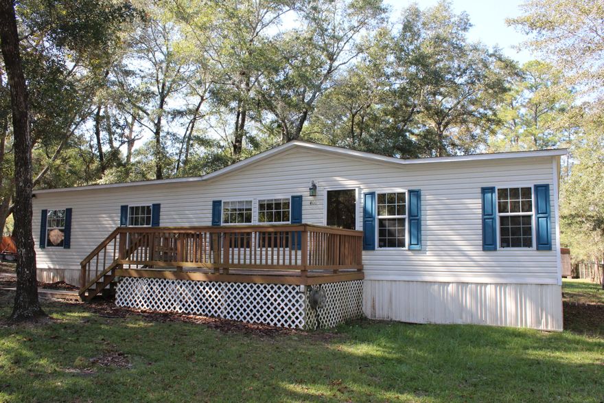 Immaculate 4 bedroom and 2 bath home with 1512 square feet located on a large lot in the desirable Freeport FL area! This home would make a great investment property or home! The home was built in 2007 and features an open and split floor plan! The kitchen opens to the living and the dining room! The kitchen features a breakfast bar, tiled back splash, and appliances! There are three bedrooms and one full bath on one side, whereas the master bedroom is on the other side! This provides for maximum privacy in the master bedroom and bathroom! The master bathroom has a walk-in shower, soaking tub, and double vanity! There are laminate wood floors throughout the home! The home features double paned windows and a storm door! The front deck is open and overlooks the wooded front yard!