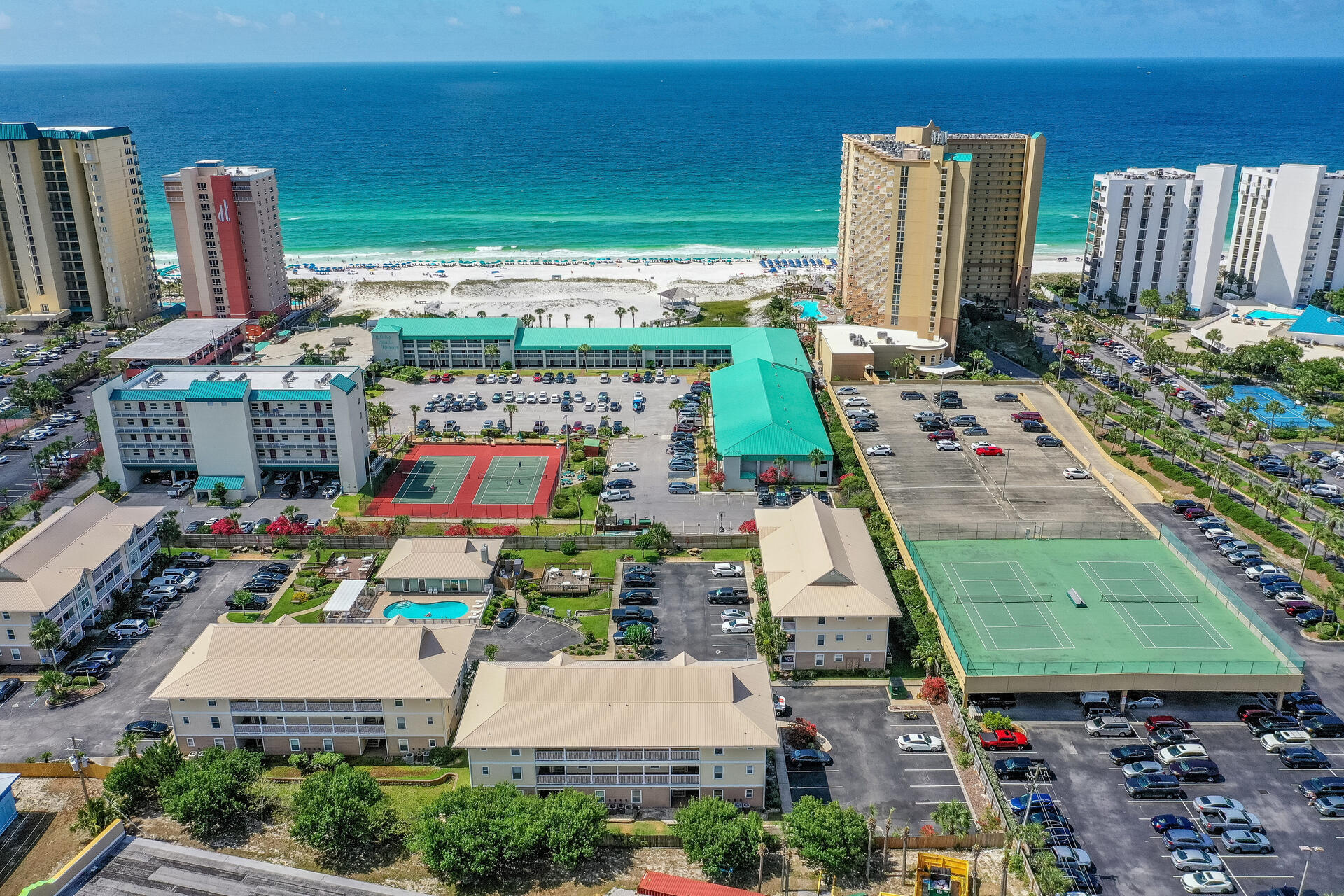 With Rental Projections of $65K - $75K, this updated, 2 bedroom, 2 bath Ground Floor, End Unit Condo with Community Pool and private beach access located in the heart of Destin across from Big Kahunas water park, near shopping and restaurants. The current owner has splurged on updates since 2018 to make this condo truly a home away from home with new laminate flooring, new refrigerator, new HVAC, new light fixtures, new ceiling fans, new furnishings, new plumbing fixtures, etc. Offered furnished and rental ready with some exclusions. Great vacation rental, 2nd home or primary residence and your pets will love the green space! The clubhouse has its own kitchen and fireplace that is great for large gatherings. Square footage/room Dimensions and are approximate and should be verified by Buyer
