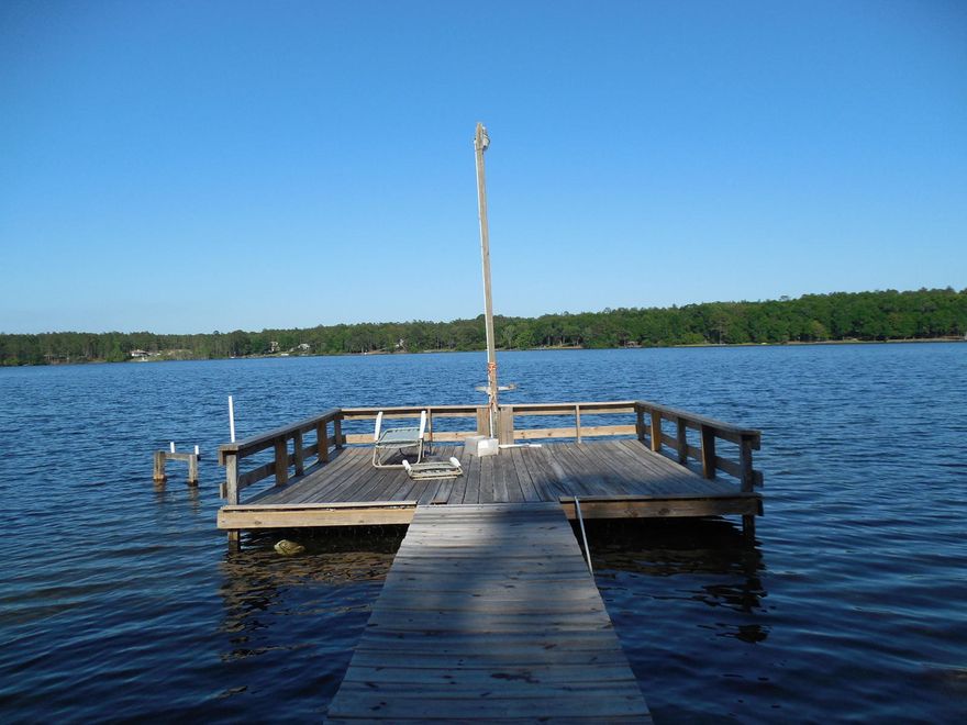 A rare and unique property located in the coveted Spring Lake Estates. This 4 bedroom, 2 bath Florida Cottage is positioned on the only peninsula located on Spring Lake. Spring Lake Estates is a private community surrounding Spring Lake, a 155 acre stocked, spring fed private lake community. Because of it's location, this home is surrounded by over 500' of waterfront on the 1.45 acre peninsula. Since the home was purchased last year, numerous improvements were done including the removal of several large trees located close to the house, the entire lot cleared of excessive undergrowth, exterior of the home repainted, new laminate flooring and trim installed throughout and new exterior grade carpet installed in the large screened in Florida Room on the back of the home facing the lake. Other improvements include the application of crushed asphalt that was placed on the driveway and in front of the home to improve parking and a new stainless smooth top stove and refrigerator that have been replaced in the kitchen. The kitchen and living area have an open design with a cathedral ceiling and skylights that adorn the room with natural lighting. Two bedrooms and one bath are located on each side of the living area. The home is mosly furnished and some new beds were replaced in the bedrooms and have never been used. Furnishings and beds can convey with a good offer. Washer and Dryer are also included.

You will find this area offers exceptionally quiet and peaceful living with a relaxed atmosphere. Great place for a weekend get away or your permanant residence to enjoy nature in a peaceful surrounding. Relax in either of the two porch swings in your 535 square foot Florida Room or take a stroll down to the dock with your fishing pole and a cooler loaded with your favorite beverages. Peaceful living and relaxation abound in this home. This home is being sold "as is" and could use some additional updating. With a little TLC, this property could be exceptional. Schedule your showing today, this home will not last for long.