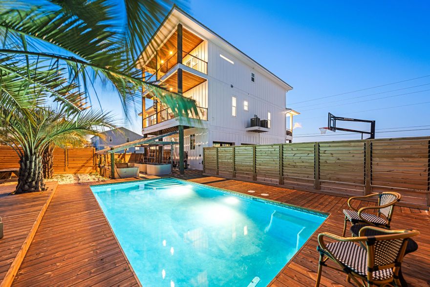 Beach life, luxury and freedom await you. This Navarre Beach gem sets on the pristine white crystal sand of Santa Rosa Island on the Emerald Coast. Enjoy close proximity to the quaint beach access or unobstructed water views from your living room or versatile kitchen. No HOA restrictions to limit your imagination. A heated in-ground, salt water pool nestled between lazy palm trees and surround by a custom wood deck, louvered privacy fence and a private garden invite serenity and relaxation. Enjoy the Santa Rosa Sound out the front and the Gulf of America from the back decks. Inside this thoughtfully planned custom home, wide plank engineered wood floors and warm wood accents stretch throughout. The kitchen is tastefully equipped with a 10' island, RO water, pot filler, granite tops, Wolf ovens, gas stove and chilled sparkling water on tap, and an elevator that serves all three floors. Gulf and Sound views continue in each of three second floor bedrooms including the master suite. An attached in-law suite can double as a master on main, including private entrance, laundry and kitchenette. The tall garage provides two parking spaces and abundant storage.

Across the bridge to Navarre is dining and quaint locally owned shops. Adjacent to the Navarre Beach community is the Gulf Islands National Seashore with its untouched beauty, and Emerald Coast communities including Destin, Sandestin, and the 30A communities of Seaside and Rosemary Beach.
