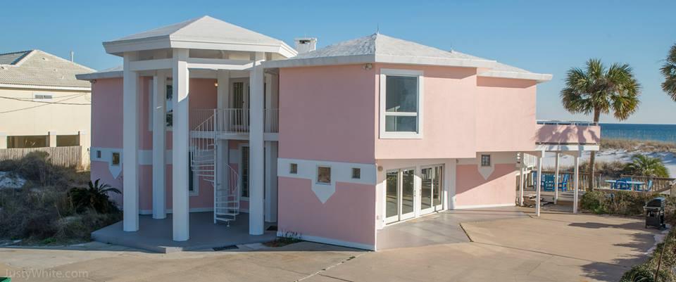 The Pink House sits on 1+ acre of pristine GULFFRONT!!!! Located on Millionaire's Row on Holiday Isle!! This uniquely designed beach home has forever views of the Gulf of Mexico! Lots of great memories have been made here! With 7 bedrooms and 6 bathrooms and multiple living areas there is room for everyone! Relax on any of the multiple levels of decks, smell the salt air, watch the dolphins play and share the memories of sunrises and sunsets. 100 feet of gulf front beauty. It would make a great permanent home, second home or vacation rental home.