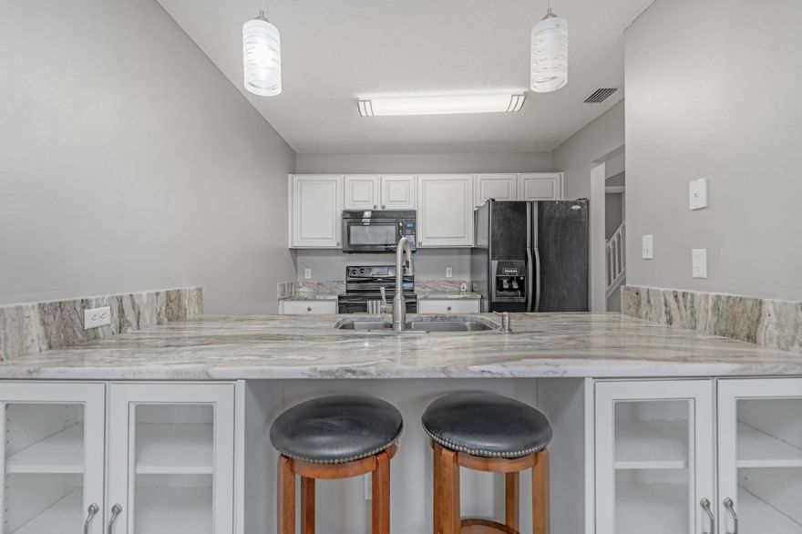 SELLER TO REPLACE ROOF WITH AN ACCEPTABLE OFFER. Charming townhome in Fort Walton Beach, FL, featuring an open floor plan, updated kitchen with granite countertops and new cabinets. Enjoy 2 large bedrooms, each with a private bathroom. This home has also been updated with modern LED lighting, a Ring doorbell, and a smart thermostat. Outside, you'll find a fenced backyard, new gutters, and updated exterior lighting. The water heater was updated in 2019. Don't miss this stylish home conveniently located close to Hurlburt and Eglin AFB and the Fort Walton shopping centers.