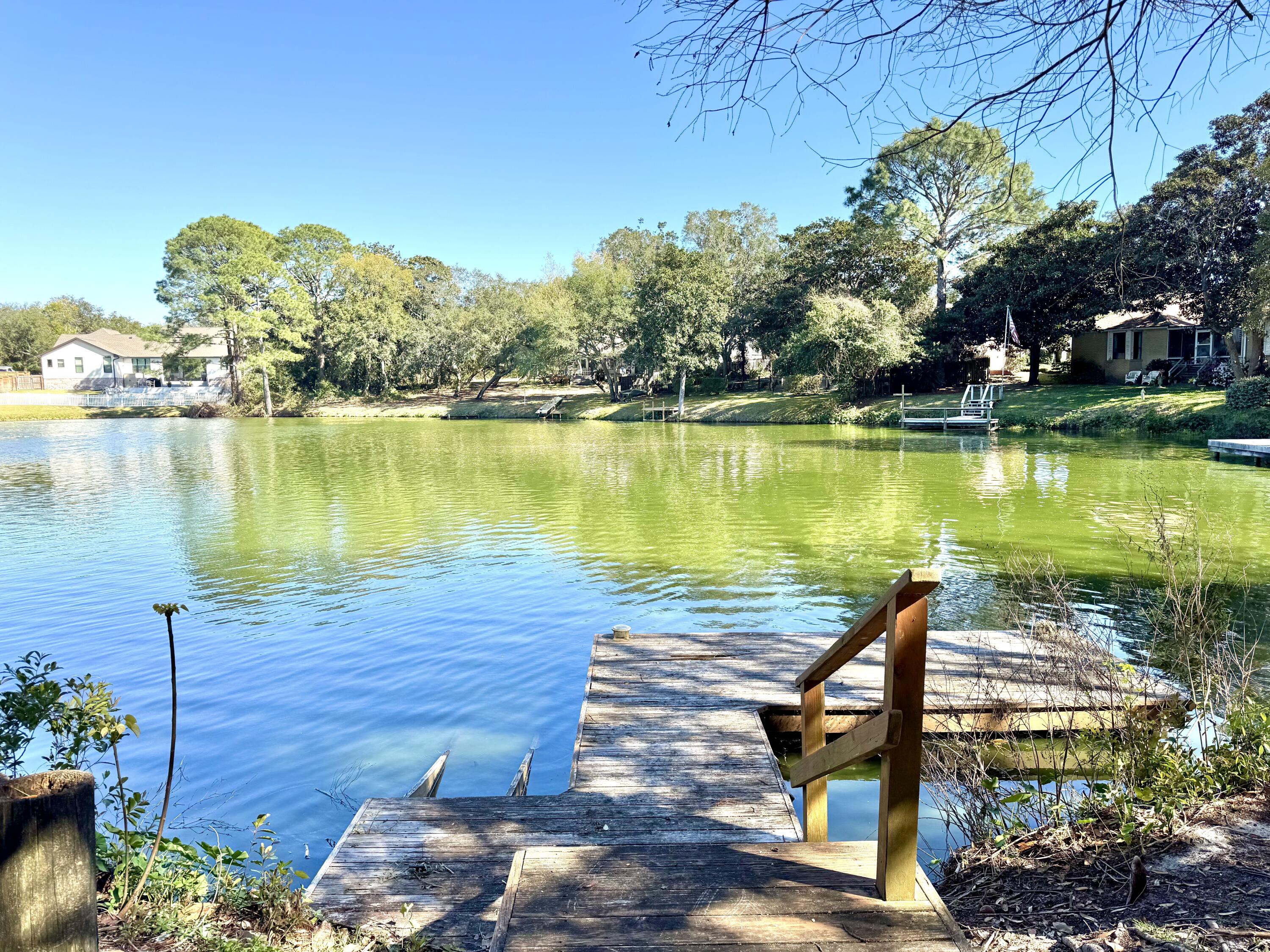 Escape to paradise in this charming, and spacious 4-bedroom, 3.5-bath home nestled on a peaceful lake in beautiful Destin. This home offers privacy amidst mature trees, serene views of the lake, multiple decks, and direct access to the water from a private dock, perfect for a small lake-fishing boat. This is a rare find in Destin, and a must see. Text to view. 850-375-7000