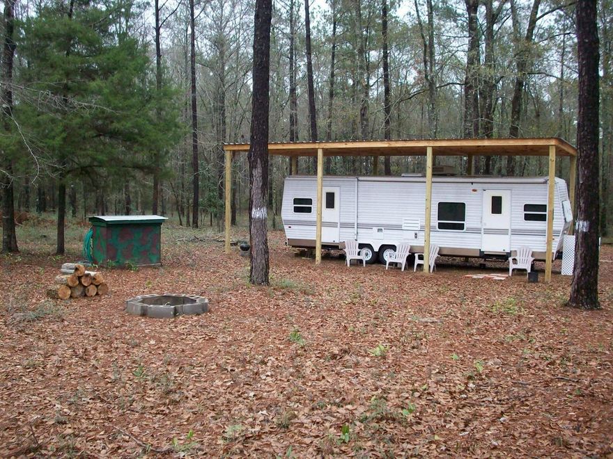 PERFECT GETAWAY! This 6.8 acre tract is a perfect getaway amongst the pines and oaks of NW Florida, yet close to the beautiful beaches of Panama City and South Walton. The gated property is situated on a county maintained road, partially cleared, and is improved with a WELL, SEPTIC SYSTEM, POLE BARN, and UTILITY POLE -- at least $10,000 worth of improvements! The 33' RV is not included at this price, but you can bring your own camper or mobile home, or purchase the existing RV for an additional amount. This property is lovely and located in a nice area of Holmes County just a short distance from State Roads 81 and 181. It's close to D. D. Eldridge Memorial Park, which has ball fields and a playground. All dimensions and acreage are subject to verification by buyer at buyer expense