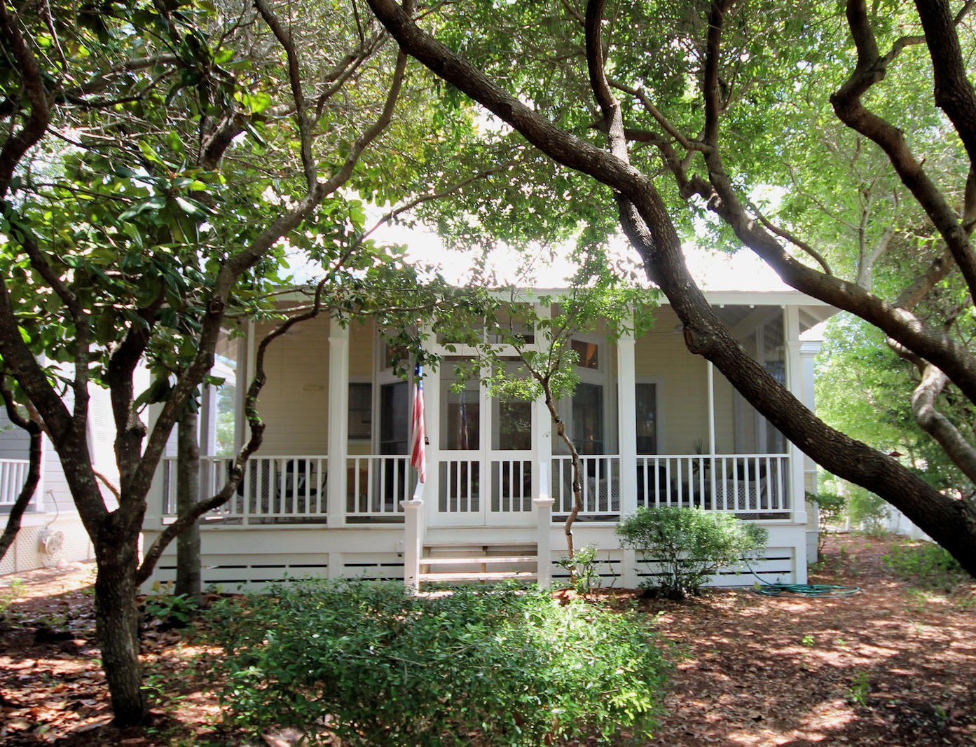 Rosewalk is an intimate grouping of cottages where all play in harmony to one another. Architects, Melanie Taylor and Robert Orr designed Rosewalk with eleven individual cottages, each with their own unique personality. The cottages and garden structures are carefully positioned to preserve the indigenous scrub oak and native plants. Three arched gateways lead to a network of secret foot paths through a beautiful canopy. C-Side cottage is just a few steps to the beach. The first glimpse of the cottage welcomes you with a front porch. Step through the double screen doors and the magic of the cottage unfolds. The porch serves as an outdoor room for extra dining or living. The living and kitchen areas are opposite one another with dining in the center. A vaulted ceiling adds volume and