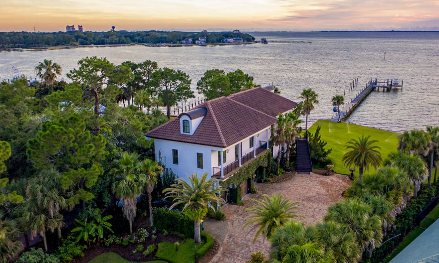 One of the finest lots in Destin, Florida, located in exclusive Cobb's Point! Measuring nearly one acre, with approximately 165' of water frontage at the coveted point of Joe's Bayou and Choctawhatchee Bay, the property features the most desired west-facing orientation, providing stunning sunset views, afternoon light, and a phenomenal deep-water dock that will accommodate large boats! Evoking the classic beauty of old-world France, the home is built with generations in mind. It features many imported finishes, as well as superior ICF construction and modern technologies designed for longevity in the north Florida climate. The flexibility of the 3-story floorplan promotes the interests of generations as well: the main living space and master suite are on the second floor, with 2 additional