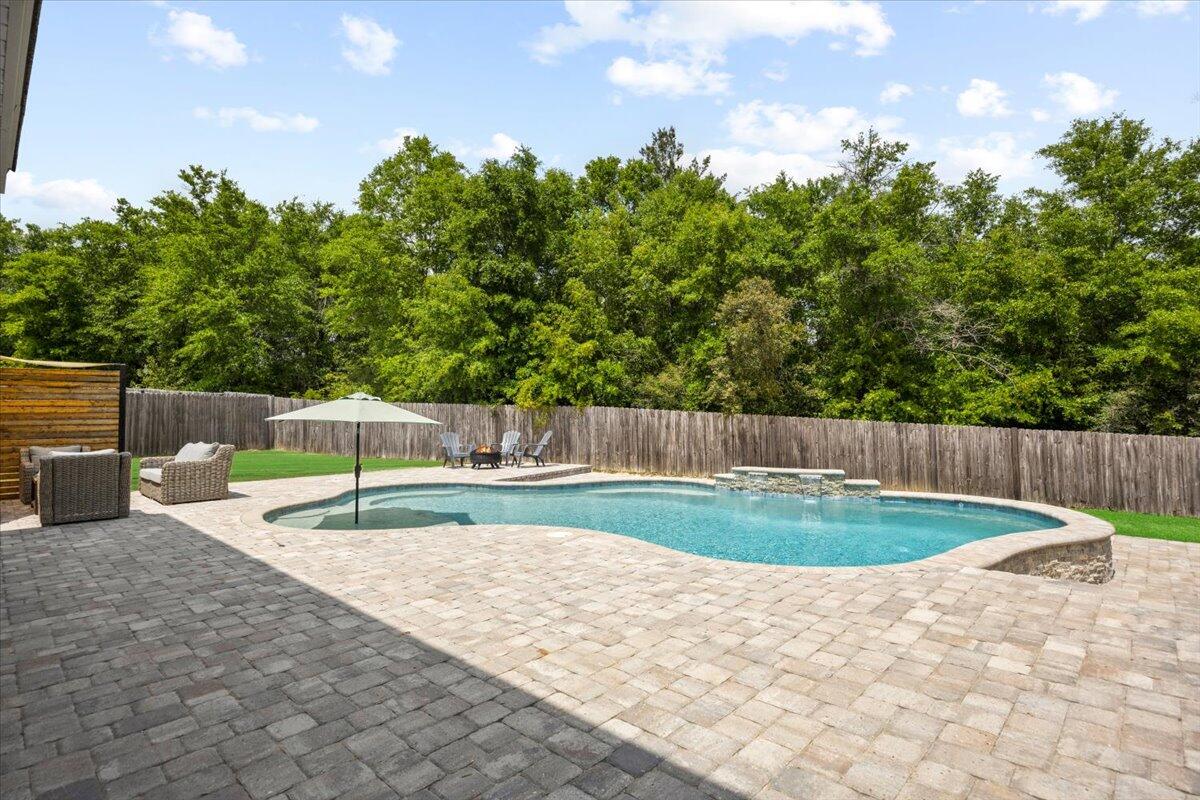 New lower price and 1 year home warranty included. Welcome to your dream home! This spacious 5-bedroom, 2.5-bathroom beauty offers 2596 sq.ft of luxurious living space and is designed to impress. Boasting an open floorplan perfect for both everyday living and entertaining. The heart of the home is the large kitchen with ample cabinet storage space and granite countertops, stainless steel appliances, a large island and eat-in dining area. The main level features a luxurious master suite complete with a huge walk-in closet and 5 piece en-suite bath, featuring a dual granite vanity, separate shower and a relaxing garden tub. Upstairs, enjoy a spacious bonus area, ideal for a media room, playroom, or home office, four generously sized bedrooms. The expansive backyard includes a sparkling 32ft Gunite custom pool with a waterfall feature, tanning ledge, built in seats, color changing lights, surrounded by gorgeous pavers. Perfect for hot summer days and outdoor entertaining. Plus, with no backyard neighbors, you'll enjoy the privacy from the surrounding wooded area.
Additional highlights include beautiful custom shiplap accents in the living area, LVP floors on the entire main floor-even the master bedroom, a two-car garage and it's located south of I-10.
This home truly has it all, schedule your showing today and see for yourself!