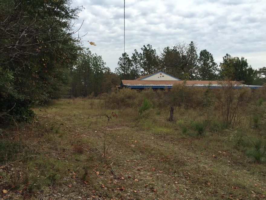 11 acre piece of land with so much potential. This property was once a growing homestead. The value is in the property. Due to the condition of the home no value was given to the dwelling. The property is equipped with a large pole barn with concrete floor and raised ceiling. The dwelling is in need of repair and completion. There is a living room, kitchen is open to the den, one and a half bathrooms. Utility room. The dwelling has screened in porches all across the front and down one side. The rear has a large covered patio. This property is sold as is.