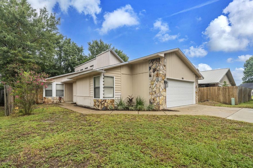 Move in ready home in Shalimar, FL with 3 bedrooms and 2 baths and 1424 sq feet! Roof replaced in 2020! This adorable home has vaulted ceilings and an open floor plan! No HOA and no flood insurance required! Just a short drive to the military bases, beaches, restaurants, and shopping! There is a two car garage and extra parking in the driveway, fenced back and side yards with a single gate, gutters, and a open patio! Enter the home and notice the updated kitchen with shaker style cabinetry, tiled backsplash, stainless side by side refrigerator, dishwasher, slide in oven and stove combination, updated lighting and a farmhouse sink! The kitchen has a barn door over the pantry, a custom chandelier, a center island that seats 2-3 guests, and custom hardware! The dining room features a large exquisite chandelier and large picturesque windows that let natural light abound. The living room features a large wood burning fireplace with a mantel and custom millwork above the fireplace. 
The homeowner has a custom entry way wall that allows guests to hang their coats and drop their bags! There are two bedrooms on one side of the home and the primary bedroom and bathroom on the opposite end to allow privacy! The guest bathroom has an updated vanity, light fixture and mirror! The primary bedroom has a sliding glass door to the open patio, a walk in closet and an ensuite bathroom. The walk in closet features a stylish barn door. The primary bathroom has a double vanity, updated mirrors, and lighting. Buyer to verify all dimensions and information. 
