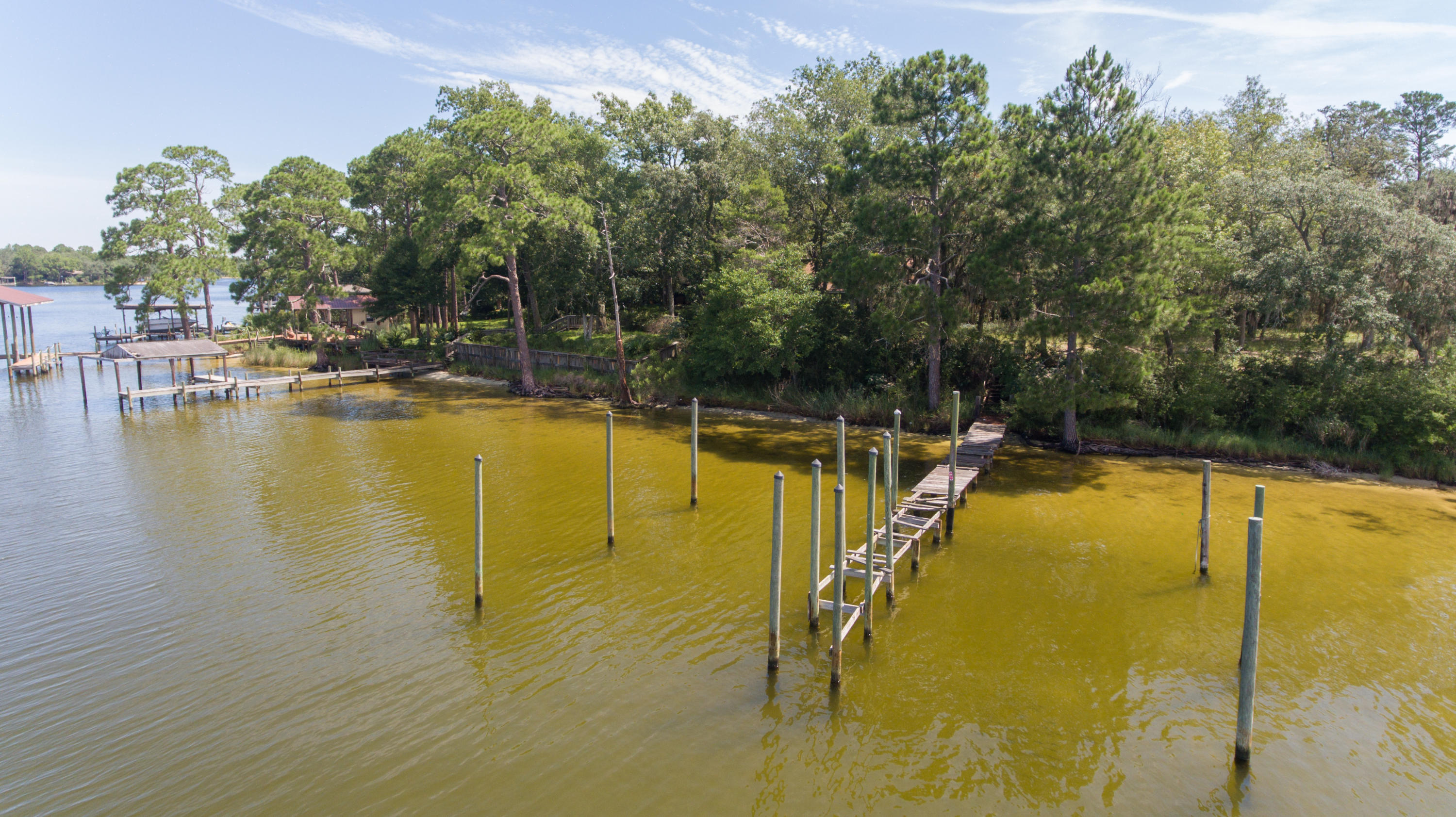 1+ ACRE WATERFRONT LOT 125 ft. on the water! Build your dream home with views facing west, situated high and dry above Garnier's Bayou. Plenty of room to build a large home and a guest home on this wide, deep, elevated lot. WITH OVER AN ACRE to build upon in a DESIRABLE NEIGHBORHOOD with NO HOA fees.