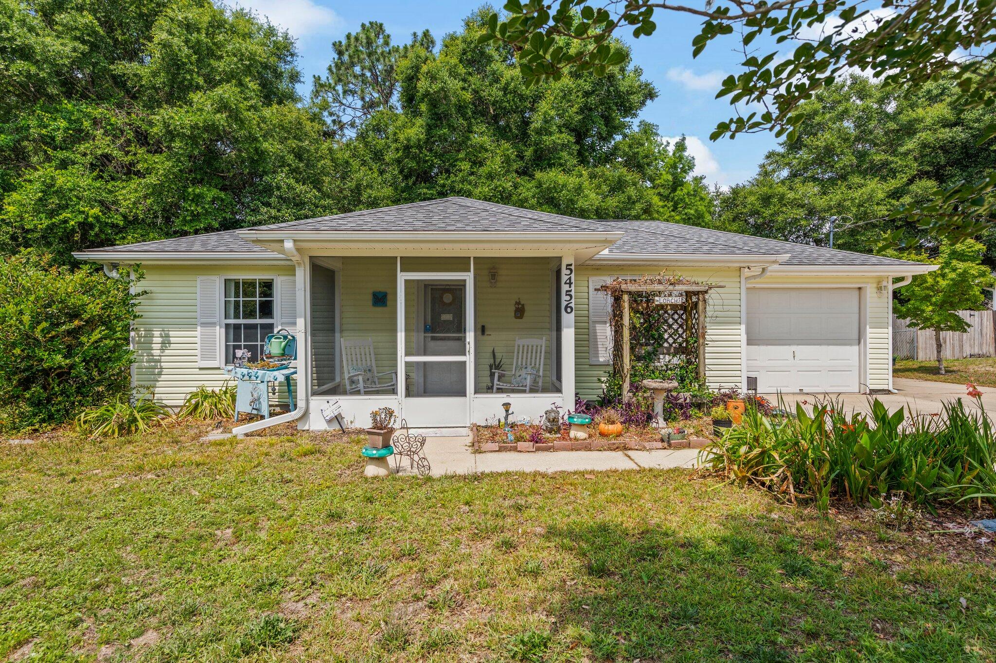 Welcome home to 5456 Haburn Street Crestview Fl! You will enjoy this peaceful sanctuary close to all the conveniences of Crestview and close to I-10. This home has been meticulously well maintained and is on a quiet street with large private lot. Pride of ownership is apparent with this lovely 2 bedroom, 2 bath home with 1 car garage. Enter through your enclosed front porch to your living room into your peaceful retreat, ample storage, laundry and one of two large bedrooms, all closets offer wire built-ins. Your master bedroom and en-suite includes a whirlpool tub and walk-in shower. Both bathrooms have tiled flooring. Enjoy making dinner in your cozy kitchen with its beautiful tile floors and oak cabinets then pass through your dining area that also has... a tiled floor, with custom built-in office/craft area to relax on your picturesque screened-in back patio as the tranquility of the backyard surrounds you. Additional out building with existing electrical provides a perfect space for extra storage or room for your hobbies, tools or gardening equipment to play in the extraordinary gardens in your naturally landscaped back yard. Owner has extended the driveway along the garage to the back yard. Perfect to park your RV, boat or toys. Roof replace 2022. HVAC 2019. Buyer to verify all square footage.