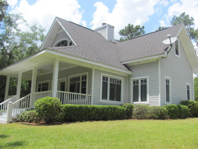 Kings Lake custom waterfront home on 3+ Acres! Designed by a Canadian architect, this home is reminiscent of homes in the Northeast. This lakefront beauty boasts engineered pine flooring throughout, raised ceilings, master on the first floor, casement windows, tri-lock door locks, alarm system, wood burning fireplace, and two central a/c & heat units, and is being sold furnished. The kitchen features beautiful corian countertops and solid maple cabinets. All appliances are GE Profile series and will convey. Stackable Maytag washer/dryer will also convey. The detached garage features peg board for easy tool organization and the pull down stairs lead to an insulated storage space (24x16). Complete with dock and concrete boat ramp. Privacy is your neighbor. Call for your appointment today.