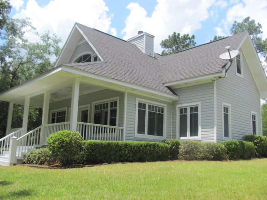 Kings Lake custom waterfront home on 3+ Acres! Designed by a Canadian architect, this home is reminiscent of homes in the Northeast. This lakefront beauty boasts engineered pine flooring throughout, raised ceilings, master on the first floor, casement windows, tri-lock door locks, alarm system, wood burning fireplace, and two central a/c & heat units, and is being sold furnished. The kitchen features beautiful corian countertops and solid maple cabinets. All appliances are GE Profile series and will convey. Stackable Maytag washer/dryer will also convey. The detached garage features peg board for easy tool organization and the pull down stairs lead to an insulated storage space (24x16). Complete with dock and concrete boat ramp. Privacy is your neighbor. Call for your appointment today.