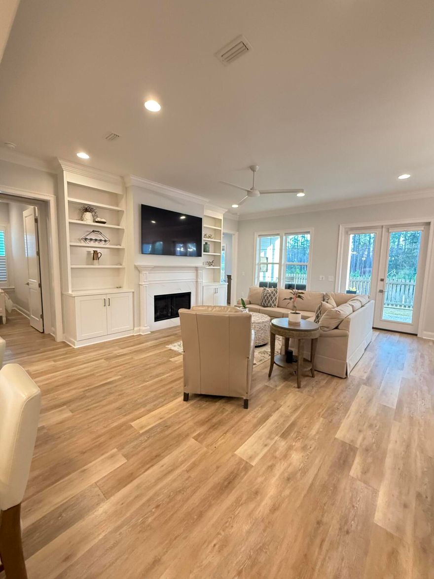 *COMING SOON* Professional photos forthcoming...Located in the highly sought-after Long Leaf Park Phase of Watersound Origins, 129 Suwannee Drive is a stunning, like-new coastal residence that stands apart from every other home currently on the market. Completed in 2023 and meticulously maintained, this exceptional property boasts over $120,000 in thoughtful, high-end upgrades--many typically found only in significantly higher-priced homes throughout the neighborhood.Set on a premier lot backing to a serene wooded nature preserve, the home offers rare privacy and peaceful views, creating an ideal backdrop for refined Florida living. Designed with the popular Huff Brady floor plan, this beautifully upgraded residence features 1,960 square feet, 4 bedrooms, and 2.5 bathrooms perfectly balancing modern elegance with relaxed coastal charm.
From the moment you step inside, the attention to detail is evident. Ten-foot ceilings, crown molding, recessed lighting, ceiling fans, plantation shutters, and custom window shades enhance the bright, open interior. The living area is anchored by a gas fireplace flanked by custom built-in bookcases, creating a warm yet sophisticated focal point while seamlessly connecting the living, dining, and kitchen spaces.
The gourmet kitchen is a true showpiece, thoughtfully designed for both everyday living and entertaining. Highlights include soft-close wood cabinetry, quartz countertops, a custom pantry, extended oversized island with additional under-bar storage, and a striking farmhouse sink. Premium appliance upgrades include a Bosch dishwasher, Bosch gas range, Samsung refrigerator, stainless steel vent hood, Sharp microwave drawer, and KitchenAid wine refrigerator. Both under-cabinet and above-cabinet lighting add warmth and functionality, while the tiled backsplash completes the elevated design.
The primary suite serves as a private retreat, featuring a spa-inspired bathroom with a double vanity, beautifully tiled shower, and a large custom walk-in closet. Two additional bedrooms share a well-appointed Jack-and-Jill bathroom, each with custom closets, while the fourth bedroomalso with a custom closetoffers flexibility as a guest room or ideal home office.
Additional upgrades continue throughout the home, including a gas package with tankless water heater, laundry room with custom cabinetry, sink, and washer/dryer combo, upgraded bathroom mirrors and towel bars, designer light fixtures, and enhanced interior finishes throughout. The two-car garage features an epoxy-coated floor, added shelving for storage, and a gas stub for a future grill. Outside, upgraded landscaping complements the natural preserve setting, enhancing curb appeal and outdoor enjoyment.
Truly one of a kind within the Long Leaf Park Phase, 129 Suwannee Drive offers an exceptional combination of location, privacy, craftsmanship, and upgradesmaking it a rare opportunity for buyers seeking a move-in-ready home with luxury features, timeless design, and the relaxed lifestyle Watersound Origins is known for.