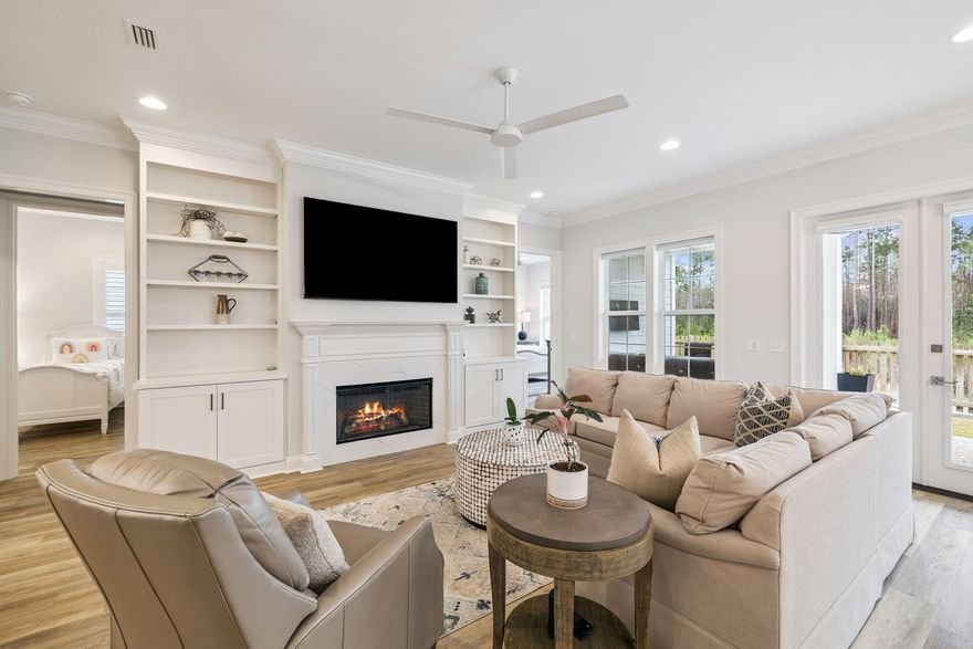 Located in the highly sought-after Long Leaf Park Phase of Watersound Origins, 129 Suwannee Drive is a stunning, like-new coastal residence that stands apart from every other home currently on the market. Completed in 2023 and meticulously maintained, this exceptional property boasts over $120,000 in thoughtful, high-end upgrades--many typically found only in significantly higher-priced homes throughout the neighborhood.Set on a premier lot backing to a serene wooded nature preserve, the home offers rare privacy and peaceful views, creating an ideal backdrop for refined Florida living. Designed with the popular Huff Brady floor plan, this beautifully upgraded residence features 1,960 square feet, 4 bedrooms, and 2.5 bathrooms perfectly balancing modern elegance with relaxed coastal charm.
From the moment you step inside, the attention to detail is evident. Ten-foot ceilings, crown molding, recessed lighting, ceiling fans, plantation shutters, and custom window shades enhance the bright, open interior. The living area is anchored by a gas fireplace flanked by custom built-in bookcases, creating a warm yet sophisticated focal point while seamlessly connecting the living, dining, and kitchen spaces.
The gourmet kitchen is a true showpiece, thoughtfully designed for both everyday living and entertaining. Highlights include soft-close wood cabinetry, quartz countertops, a custom pantry, extended oversized island with additional under-bar storage, and a striking farmhouse sink. Premium appliance upgrades include a Bosch dishwasher, Bosch gas range, Samsung refrigerator, stainless steel vent hood, Sharp microwave drawer, and KitchenAid wine refrigerator. Both under-cabinet and above-cabinet lighting add warmth and functionality, while the tiled backsplash completes the elevated design.
The primary suite serves as a private retreat, featuring a spa-inspired bathroom with a double vanity, beautifully tiled shower, and a large custom walk-in closet. Two additional bedrooms share a well-appointed Jack-and-Jill bathroom, each with custom closets, while the fourth bedroomalso with a custom closetoffers flexibility as a guest room or ideal home office.
Additional upgrades continue throughout the home, including a gas package with tankless water heater, laundry room with custom cabinetry, sink, and washer/dryer combo, upgraded bathroom mirrors and towel bars, designer light fixtures, and enhanced interior finishes throughout. The two-car garage features an epoxy-coated floor, added shelving for storage, and a gas stub for a future grill. Outside, upgraded landscaping complements the natural preserve setting, enhancing curb appeal and outdoor enjoyment.
Truly one of a kind within the Long Leaf Park Phase, 129 Suwannee Drive offers an exceptional combination of location, privacy, craftsmanship, and upgradesmaking it a rare opportunity for buyers seeking a move-in-ready home with luxury features, timeless design, and the relaxed lifestyle Watersound Origins is known for.