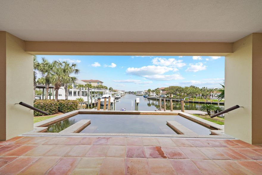 Prime waterfront with convenient access to the beach.This location has amazing gulf & harbor views unlike any on Holiday Isle.  Inspired by the architecture in Mexico and Costa Rica, this very custom home show cases authentic Spanish tiles adorning the main living spaces, each tile a unique piece of art. The concrete construction adds to peace of mind against the elements. The open-air floor plan effortlessly transitions between indoor and outdoor living space. Perfect for entertaining with ample parking and bedrooms are all ensuite.The upstairs living area can be accessed by stairs or an elevator.  The Primary bedroom on the top floor has a large private balcony as well as a large walk in closet and a separate office space.