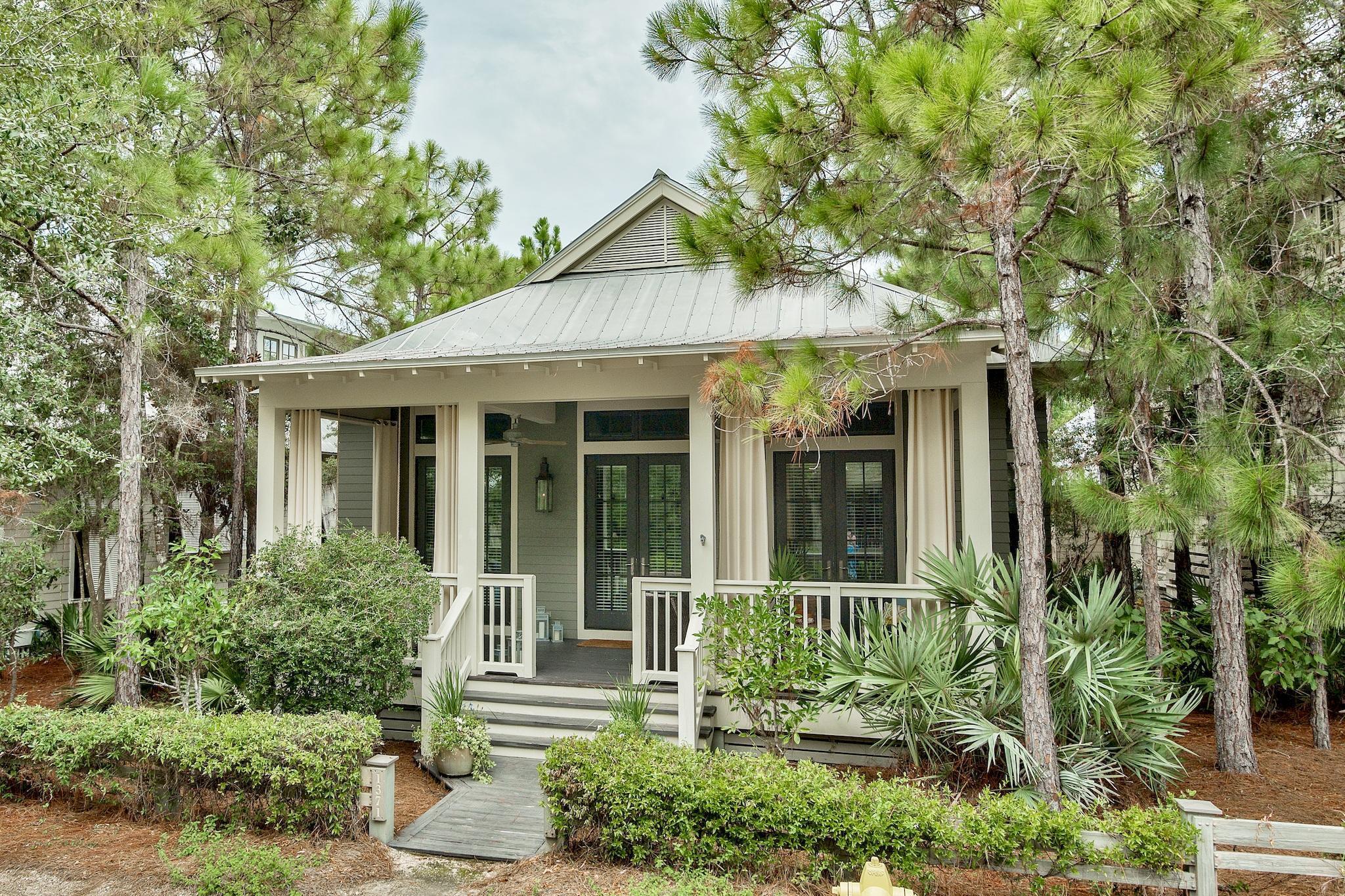 Located in the Camp District of WaterColor Phase II. This 3 Bedroom, hall bunks, teen suite loft and 3 Bathroom home is ready for your enjoyment, a rental property investment or both! Offered beautifully furnished and move in ready, the front porch welcomes you with gas lanterns, swinging bed and sitting area. Stunning reclaimed antique pine floors give way to an open floor plan, vaulted ceilings and wood planked walls. The home, built by Chris Clark, with custom cabinets, two fireplaces, large kitchen island & pantry leave room for everything and space for everyone. The back screened in porch leads to you the grilling area, outdoor shower and parking for 2. Steps to Camp WaterColor and close to Publix. The WaterColor Amenity Expansion Project special assessment has been paid in full