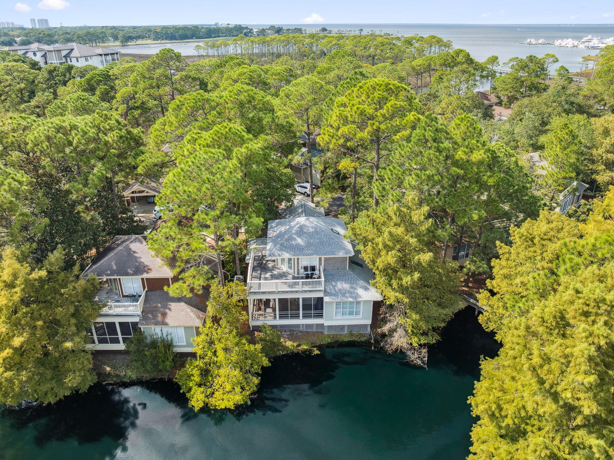 This high-performing vacation rental in Sandestin's Baypine neighborhood just got a major refresh! The exterior has been completely repainted, giving the home a crisp, coastal feel that looks amazing. Located on a beautiful tree-lined street, this 3-bedroom, 3-bath home offers an unbeatable location within easy walking distance to the Village of Baytowne Wharf, Sandestin Tennis & Pickleball Center, and the Phil Hummel Community Pool. A golf cart is also included for effortless access to beaches, golf, dining, and shopping throughout the resort.You'll find a spacious layout with an open kitchen/dining/living area opening up to a BIG screened porch overlooking a lake. There are 2 bedrooms downstairs (one with custom built-in bunks) and the primary bedroom upstairs with a balcony. Whether you're seeking a strong investment property or a second home, this home offers rental-ready value in one of the most desirable areas of Sandestin. Find your next chapter here in Sandestin!