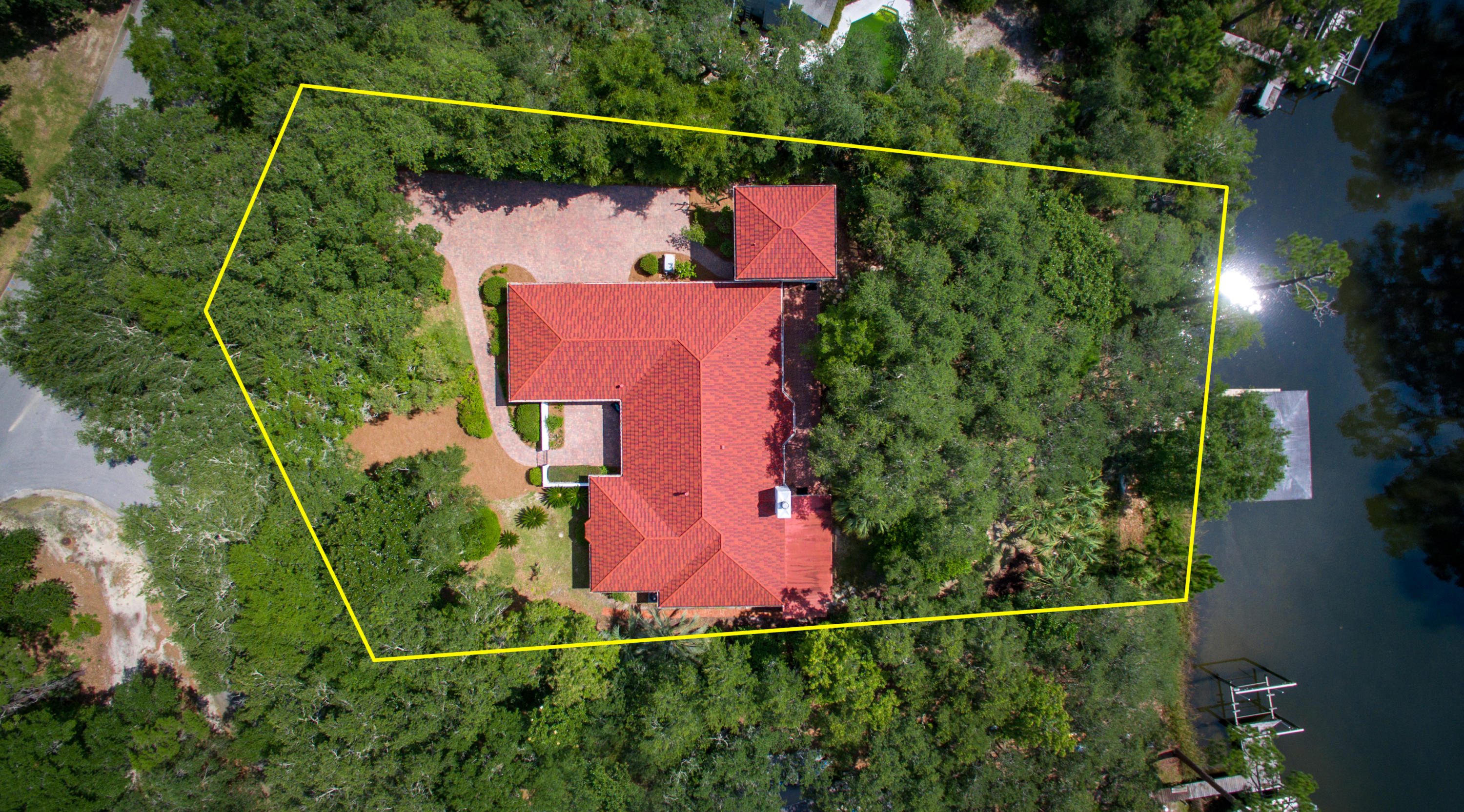 A rare opportunity to own a waterfront estate on Shirks Bayou on the secluded street of Weeden Island. This well cared for home is situated on 3/4 acre with majestic Live Oak, Palm and fruit trees. As you walk along the brick paver path through the courtyard to the front door you can immediately feel the love and care that has gone into this home. The main house has 3 bedrooms, 2.5 bathrooms and the guest cottage has 1 bedroom, 1 bath and a gym. Recent upgrades include: new premium stone-coated metal roof (2017) with transferable warranty, new interior paint in selected rooms (2018), new light fixtures in selected rooms (2017), new gutters and downspouts (2018), Lennox HVAC (2015), and select Anderson windows (2018). Request additional sheet for entire list of upgrades. The open layout offers hardwood floor in the bedrooms, dining room and guest house with tile flooring everywhere else. Two living spaces: great room with brick gas fireplace and den perfect for watching a movie or enjoying a good book. Huge master suite with crown moulding, ceiling fan, wonderful window seat and giant walk-in closet. En-suite master bathroom remodeled by Randy Wise features double sinks, separate make-up area, soaking tub and large walk-in tiled shower. Additional 2 bedrooms are generous in size with good closets and ceiling fans. Both bedrooms have french doors that open up onto the brick paver back patio that runs the entire length of the house. The guest cottage is two-stories with the first floor being used as a gym and the second level as a 1 bedroom/ 1 bathroom oasis. It feels like you're living in a tree house overlooking the spectacular bayou. The backyard has specifically crafted flower beds that have attracted over 65 species of butterfly/hummingbirds. These wonderful tiny creatures are a source of wonderful beauty. A well pump runs the sprinkler system to ensure landscaping stays green and beautiful. The entire backyard is fenced with a full service covered boat dock to include water and electricity plus a fish cleaning station and boat lift. ALL dock pilings have been professionally wrapped to prevent marine damage commonly found in saltwater. Additional features of this estate include: a separate storage shed for lawn equipment and garden tools, over-sized two-car garage with three storage closets, plus hurricane shutters for all windows, "on demand" whole house generator and gym (in the guest house) equipment available for sale. This property is a dream come true to live the water lifestyle ... a once in a lifetime opportunity. Easy access to both Air Force bases and all the Emerald Coast has to offer. Buyer to verify square footage.