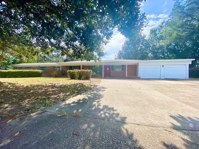 A LOT of home for the money! Main house features: large living room, eat-in kitchen & a formal dining room/office/bonus room. Master bedroom w/ full bath. Two additional bedrooms & hall full bath. Separated by double doors is a large great room w/ fireplace & kitchenette w/ pantry. This space would be ideal for an entertainment space w/ the built in bookcases. This area also has a nice size bedroom, full bath & walk-in-closet, so it could easily be a true Mother-in law suite. With this much space, you can really use your imagination to make it work for your family! All brick home on a large corner lot. New well & deep well jet pump 2 yrs ago. Solar panels will be paid off at closing. All new impact windows being installed prior to closing. Nest thermostats & security system. Major systems:
