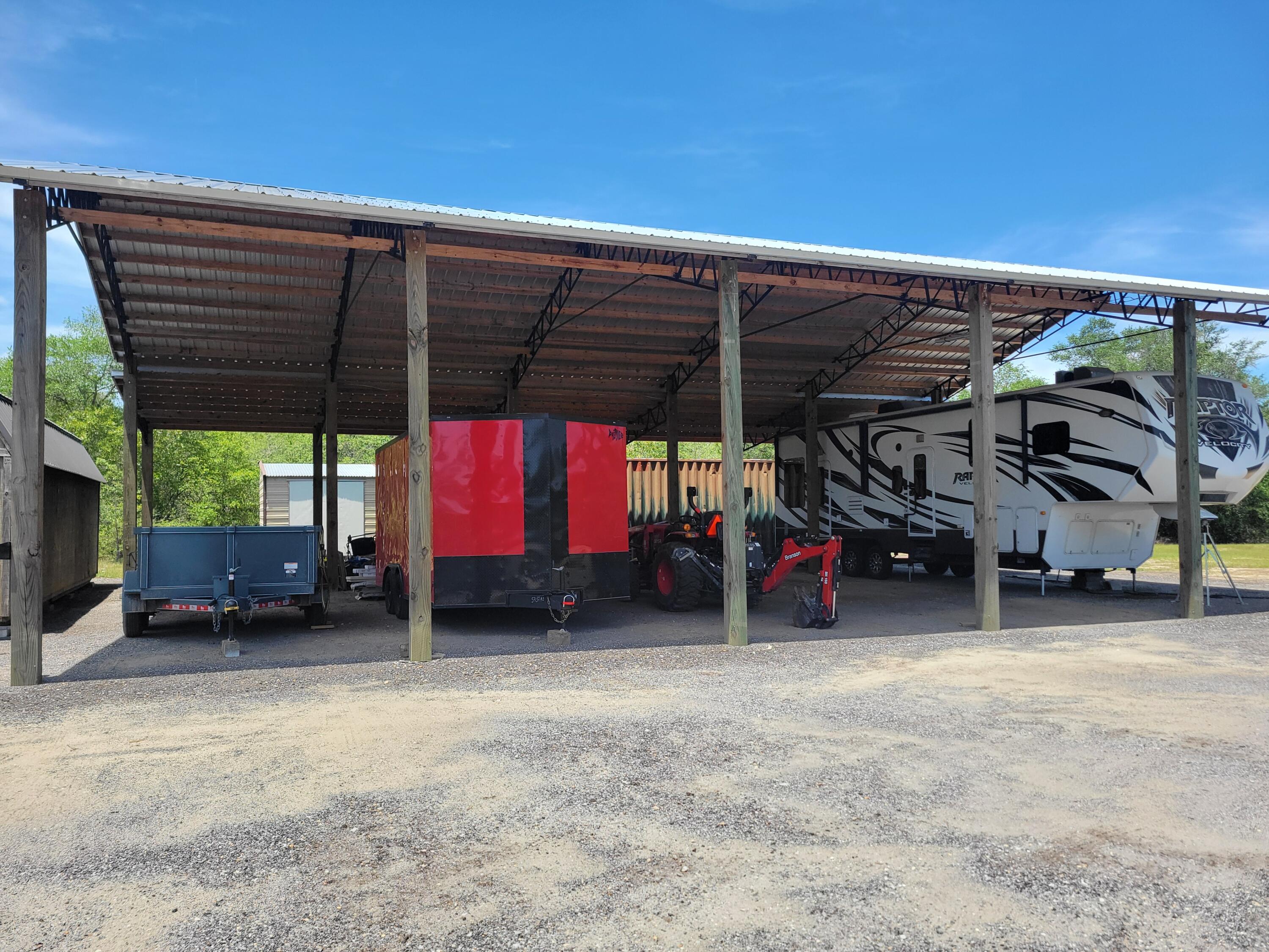 4 acre tract more or less on paved road, super size pole barn 60' x 44' with 26 gauge metal roof, 8x8' posts, with a 200 amp electrical box, and heavy gravel floor built 2021. Included in the sale is TWO - 8x40 containers, both spray foam insulated Property has a new culvert just installed. Partially cleared with several home sites to pick from to build your new dream home. Please call an agent to view the property.