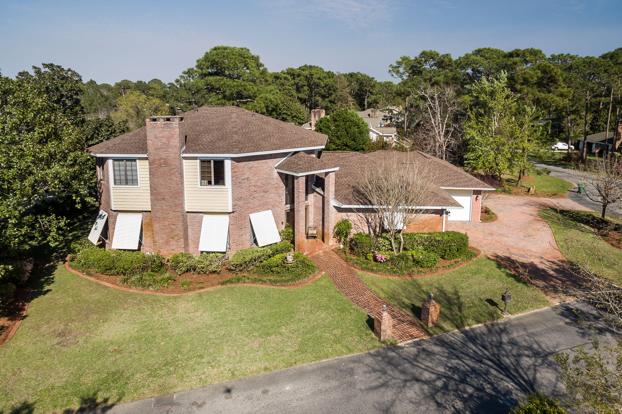 EXQUISITE home custom built by Gary Miller with bay views and an enclosed pool on a .46 acre golfcourse lot in the gated community of Southwind of Bluewater Bay. When you enter this home through the double front doors, you will find yourself in a stunning foyer with marble floors, a 25' ceiling and an impressive curved staircase - the perfect place for prom and bridal pictures! Through the foyer you will see the large enclosed gunite pool with a covered outdoor living area AND a hot tub as well the perfect place for outdoor living! There are 3 distinct living areas in this home, the front living/dining room, the family room open to the gourmet kitchen AND a rec-room adjacent to the garage the perfect home for a large family or for someone who needs some extra space. This home is built