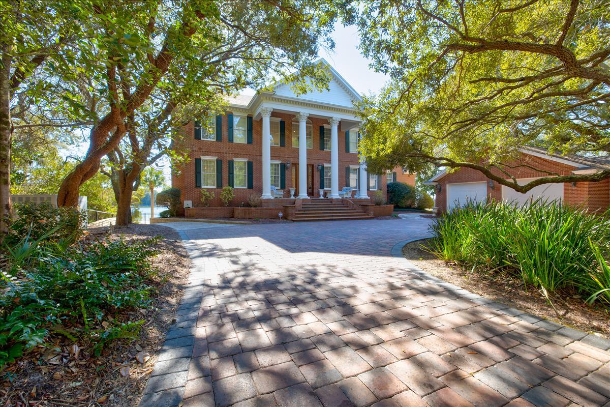 Welcome to 83 Poquito Road, a classic colonial-style bayou-front estate meticulously designed for gracious entertaining and everyday living. This exemplary custom built 1.48-acre gated estate is uniquely situated on Poquito Bayou offering over 450' of waterfront, a rare private peninsula and second-to-none open bayou views. Spanning just shy of 6,200 square feet, are 4 stately sized bedrooms with 4.5 bathrooms; however, spaces may be modified to create a 5th, 6th or 7th bedroom. This estate celebrates the art of fine living with spacious rooms revealing an artful eye for casual luxury. As you enter through the iron gates, enjoy the mature lush landscaping with an expansive brick paver circular drive and exquisite mahogany front door opening into a grand two-story foyer with an inviting