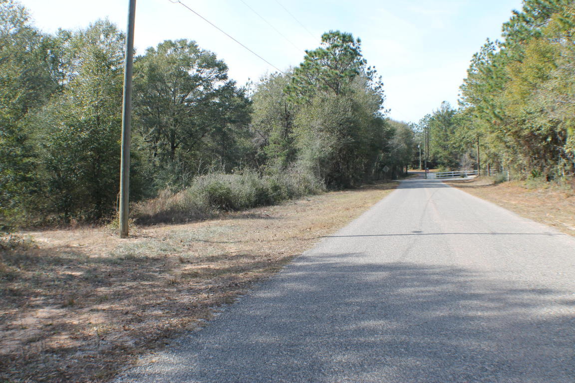 Homesite Dream! Huge hardwoods small creek and lots of Paved road frontage! This location is in the Auburn area near the new developing commercial of North Crestview! With highway 85 near by its just a quick commute to Crestview, Eglin and Destin Beaches! Bring you barn, RV and your house-plans today! Sale contingent on satisfactory lot split. Additional acreage available!!