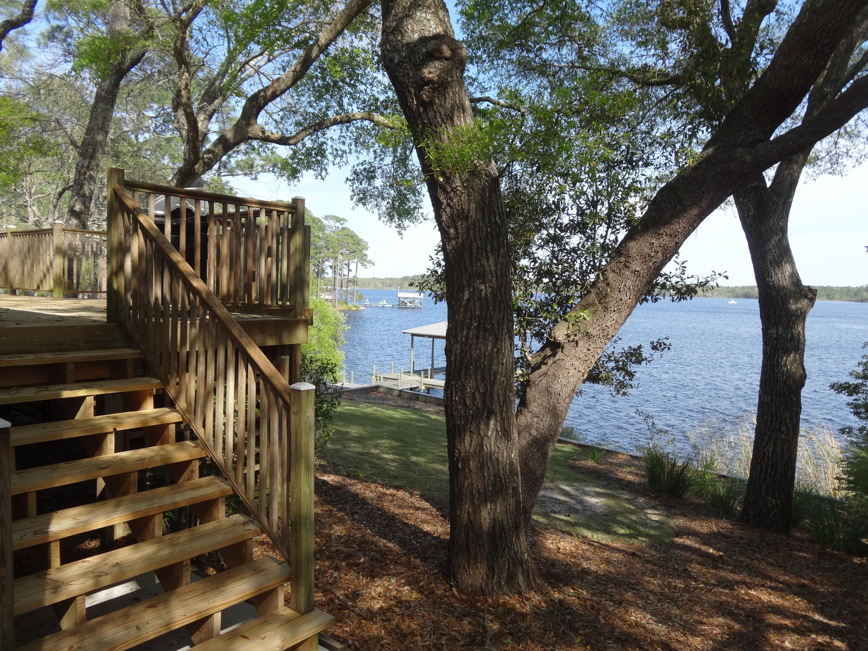 One of the Finest Waterfront Properties available ... with 158 ft of deep water on Rocky bayou .. with great elevation.This home has been completely redone throughout .. Kitchen . Appliances . Countertops . Flooring . Windows & Doors . Air Conditioning systems . Bathrooms . Decks . Dock . Metal Roof . these are just some of the areas . 20' x 16' Rec Room.Large Wood Deck (25' x 20') overlooking the Water .4 gar Garage with extra Work Shop areas & Storage . 10' x 3' work bench . New Garage Doors with quiet openers (German) .Professionally Landscaped & maintained.Covered Boat slip (32' x 12'x 15' H) and lots of decking . Lower Decks at the water (20' x 15') and (70' x 8') .Extra parking for both an RV with power & waste hook up . plus storage for a utility trailer.