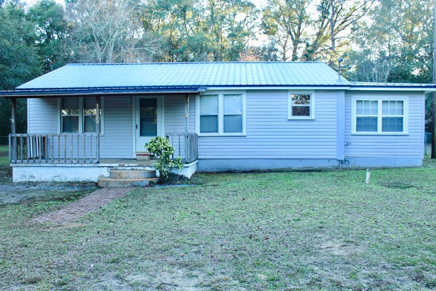 This country home on an acre of land was renovated in 2002 to include raising the entire house and installed a new foundation, new heat pump, new metal roof, vinyl flooring, new vinyl siding, replaced all of the plumbing, enclosed the porch, and installed a new chain link fence. The porch is a great place to gather with family & friends! There is large garden spot in the corner of the property, lots of fruit trees, and 2 shed and one with electric (the shed that is wired for electric is not permanently connected to service. All exterior buildings are convey ''AS IS''. The dining room was replaced 5 yrs ago, hot water heater was replaced 8yrs ago. There is an above ground pool. The 3rd bedroom doesn't have a built-in closet but armor conveys. The seller recently updated the bathroom.