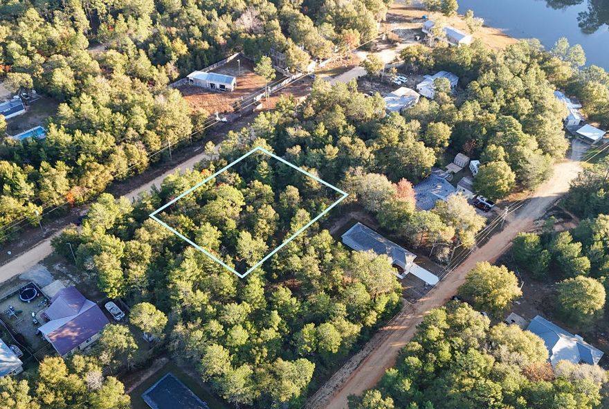 Spacious 0.46 acre wooded lot in Mossy Head/DeFuniak Springs. Oakwood Hills Unit III is located on a well maintained county dirt road, just about 400 ft off of a paved road. No HOA Restrictions means flexibility to live your way-ideal for a mobile home, manufactured home, or RV. Power lines run along the street and public water is available with tap fee. A septic system would be required for waste disposal. Conveniently located with easy access to both I-10 and Highway 90, commuting to DeFuniak Springs or Crestview is a breeze. Start your new chapter with the peace and privacy of rural living while still being close to all the amenities and services you need.