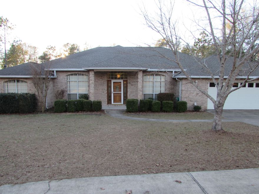 So many features....Home is all brick, sits on a 2.4 acre lakefront lot and has a large deep pool with screened pool enclosure! As you walk in to the home, there is a large foyer and to the right is the dining room with high ceilings, wood flooring and chair rail. To the left through french doors is an office/formal living room. The living room is spacious and has wood flooring, gas fire place, ceiling fan and sliding glass door to the screened porch which overlooks the pool. To the left of the living room are the 3 spare bedrooms. One bedroom has an attached bathroom with cultured marble vanity and shower and tile flooring. The other 2 bedrooms are near the 3rd bathroom.