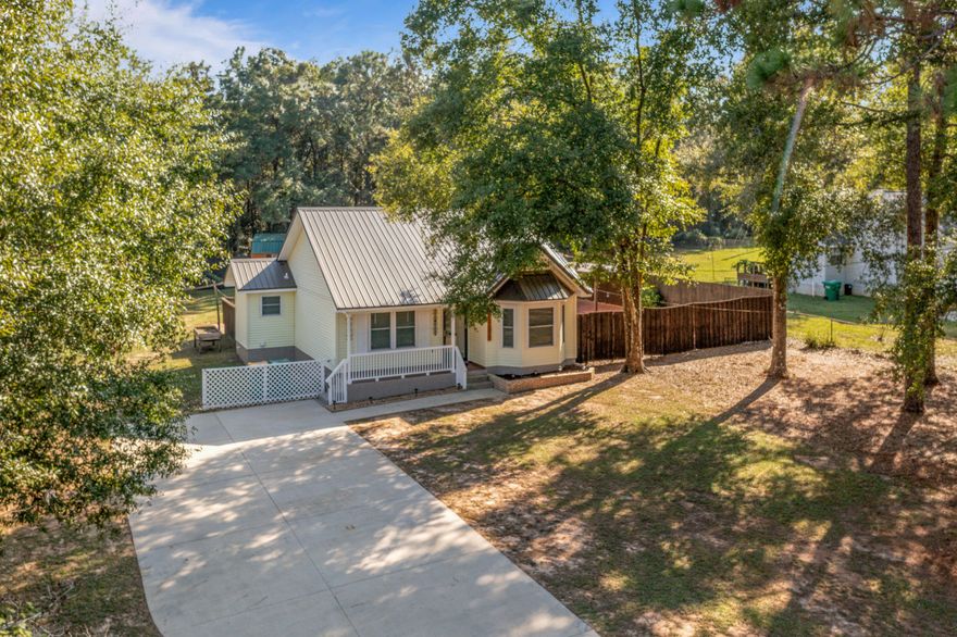 Walk into an open floor plan in this absolutely gorgeous and amazing 2 bedroom 1 bath cottage on approx. 0.45 acres. Covered front porch and an approx 18' x 20' back porch.   The house has tile floor throughout the bedrooms and bathroom and LPV in the remaining portion of the home.  The kitchen is bright with ample counter and cabinet space and a farmhouse sink.  The backyard has a privacy fence around three sides with lawn shed and he/she shed (31.25' x 10.5' - this has been divided into 3 rooms - double loft, AC in one room, lean to on one end and double doors with a ramp on the other).  In addition, the back yard has paving stones to the shed, entertainment area and fire pit.   Call your favorite realtor so you can view this gorgeous location