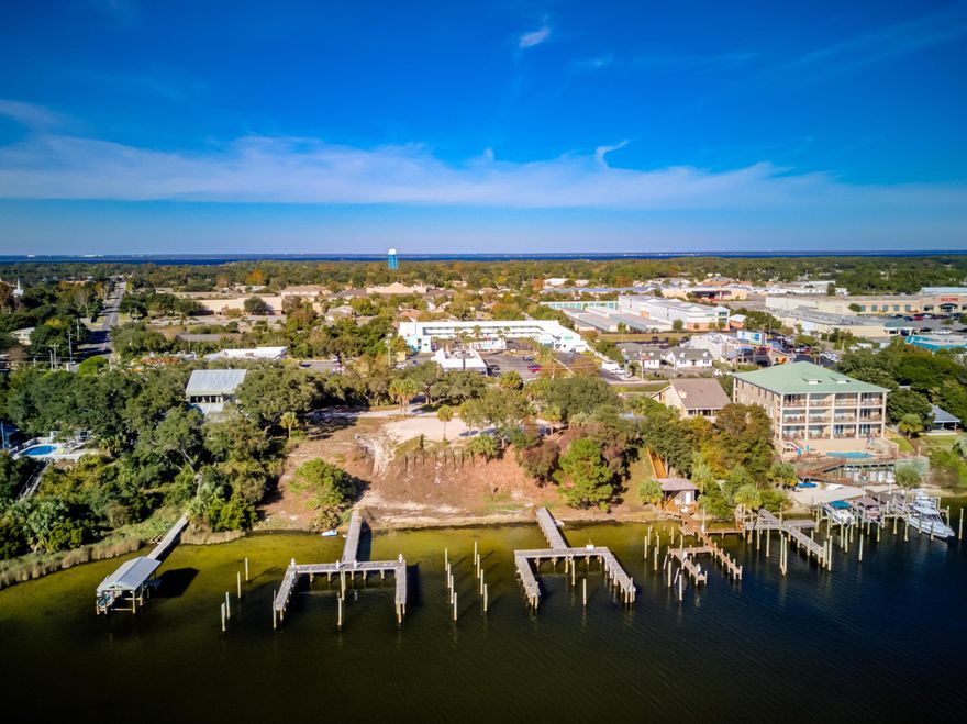 SIGNIFICANT PRICE REDUCTION!!Superb redevelopment site perched upon a stunning elevation, which enjoys a scenic vista across Destin, Florida's coveted Harbor, admiring breathtaking views of the East Pass and Gulf of Mexico! Such convenient access with unprecedented views is a rare and unique opportunity to debut new construction on the contiguous (4) lots, each measuring approximately 50' x 219', containing a total of (8) deep-water boat slips! (two slips per lot) The site is zoned Low Density Residential-Harbor (LDR-H). Please refer to the uploaded property survey. Property survey and dock configuration uploaded under Documents tab at header of this listing.