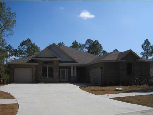 Brand NEW beautiful 4-side brick home loaded with luxury finishes. Volume ceiling throughout combined with numerous arched openings and open floor plan for a dramatic look/feel. 42'' raised panel cabinets, granite c-tops in kitchen and baths. Lots of hardwood, oversized ceramic tile in bathrooms and upgraded carpet in bedrooms. Large tile shower in master bathroom. Oversized covered lanai. Built with ''Energy Smart Features'' for lower energy cost. Courtyard style 3-car garage. 2-Year Builder warranty AND 10-year structural warranty. BAY COVE is a low density neighborhood of only 27 homes on large, private, heavily treed homesites.