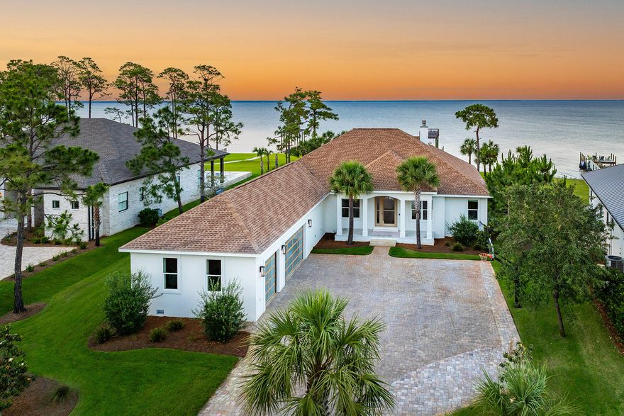 Introducing a one-of-a-kind Bayfront masterpiece where modern design meets effortless luxury. Completely reimagined in 2023 with over $1M in high-end renovations, this stunning retreat sits on 0.87 acres with 110 feet of private frontage on the Choctawhatchee Bay. Enjoy endless water views, vibrant sunsets, and true indoor-outdoor living with six sets of brand-new wall-to-wall sliders. At the heart of the property is an oversized private pool and spa surrounded by a paver sundeck with loungers and an outdoor dining areaa"perfect for relaxing or entertaining while taking in the bay. White oak flooring, artisan clay zellige tile, and soft natural light create a serene, elevated atmosphere throughout the home. Inside, the home offers four bedrooms, three full bathrooms, a private office with custom glass-and-brass partition doors, and a media room with a dramatic white oak feature wall. The kitchen is a showstopper, featuring a massive 5'x12' quartzite island, custom white oak shelving, all-new cabinetry, and a premium side-by-side refrigerator and freezer. Additional features include oversized primary closets, floating vanities, a designer mudroom, and a beautifully appointed laundry space. Nearly every detail has been updatedtwo new HVAC units, a whole-home Generac generator, custom garage doors, gas lanterns, spray foam insulation, and a newly installed sea wall. The double-decker Trex dock with boat lift and the three-car garage with 13' ceilings add both convenience and value. Just minutes from the world's most beautiful beaches, premier dining, boutique shopping, and top-rated schools, this rare bayfront property blends privacy, luxury, and location in one unforgettable package.