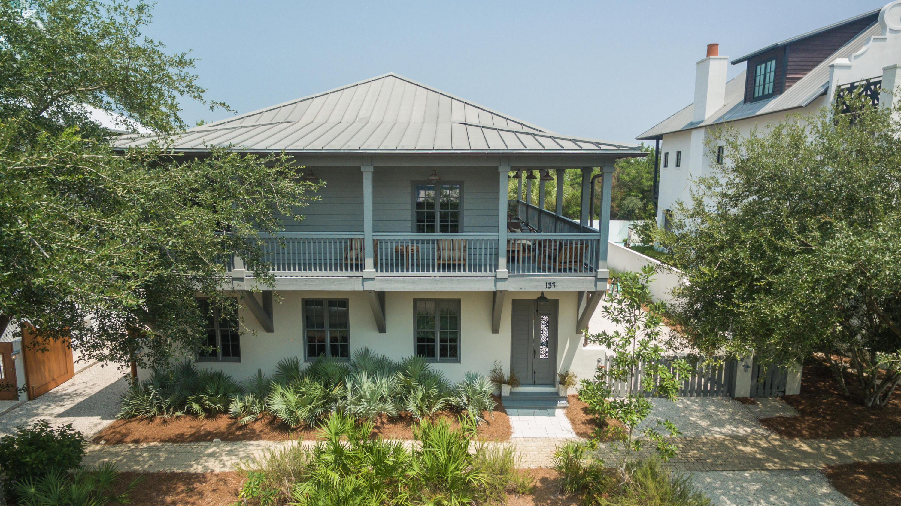 Beautifully renovated home in Rosemary Beach with over $370K invested this is a must see. Room for a pool, fire pit, and carriage house, or entertaining as is with outdoor dining, and expansive gated parking for guests. Ideal floor open floor plan with a chef's kitchen and master on the first floor. Second guest Master bedroom and dual sink bathroom upstairs with two additional guest bedrooms and bath. The main floor features an open kitchen and vaulted living room. The large master bedroom with adjacent master bath is fitted with a jetted tub, separate shower, dual sinks and heated floors. The first floor has a large laundry room complete with new Kenmore Elite washer and dryer and a spacious owner's closet. The second floor has three bedrooms and two full bathrooms, surrounded by a wra