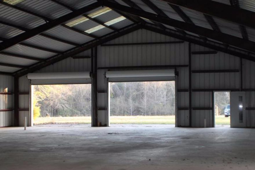 2.8 Acres in the country zone Agricultural . 3 roll up doors, 2 man doors, metal building 60x100 concert floor. Plumbing is stubbed out. Listing agent has ownership interest. lessor retain ingress/egress easement along property line. Bring you storage goods, tractors, boats and RV's. Private Storage !