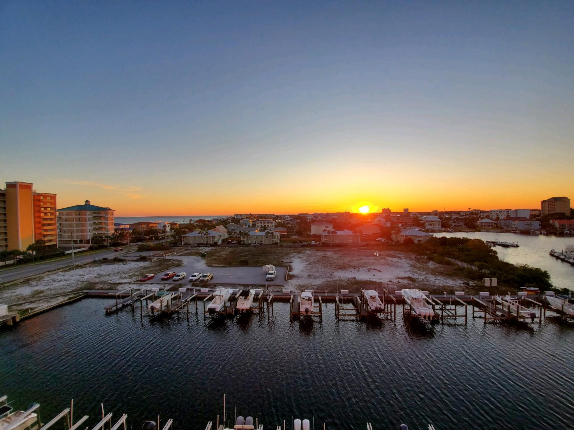 Under contract but kick out clause is in place. Amazing views of the Harbor and Gulf of Mexico from nearly every room of this spacious 2 bedroom 2 bath condo. Living room, dining room and kitchen are open to one another and have magnificent views. There is a large balcony to enjoy year round sunsets and fireworks in the summer. Master bedroom has double vanity, whirlpool tub and separate shower. This unit has upgraded flooring in bedrooms and living room and newer a/c. Harbor Landing has deeded beach access, a gym, a gorgeous resort style pool plus a harbor front owner's only pool. Short term rentals are allowed here, but building has a lot of owner occupied/second home units so you have the best of both worlds. Boat slips and garage spaces may be available to purchase separately.
