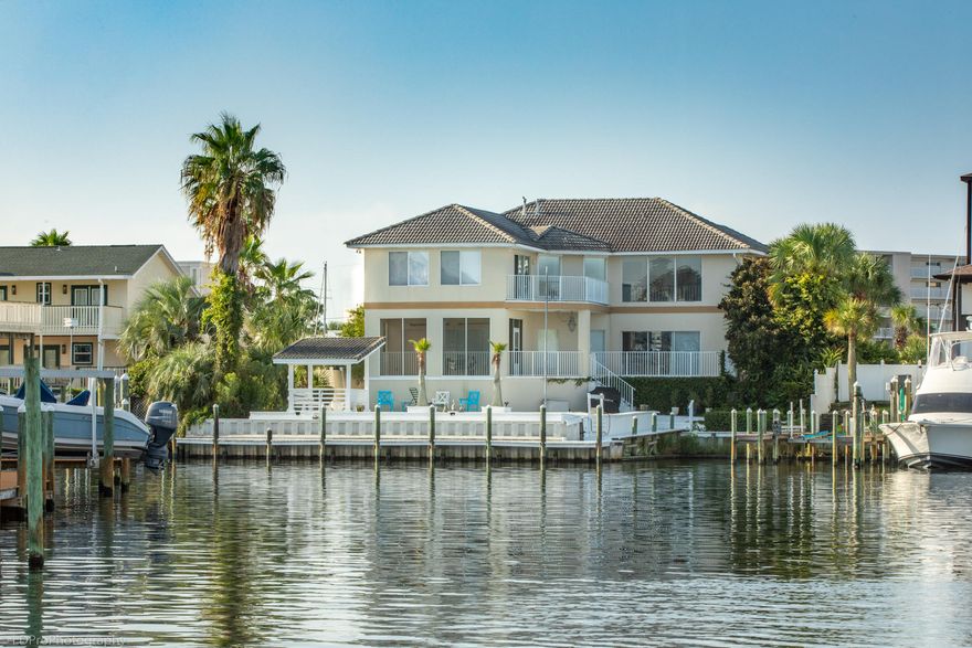 Easy boat maneuvering at this wide-water 'T' on the Destin Harbor canals (maintained at 6 feet depth) ... 61 ft alongside dock, and an upland boat slip 17 feet wide for a boat up to 48 ft ... heated pool served by a hot tub ... Vera Cruz Dr is just one block off the beach ... This modern floorplan presents water vistas from the entry & living room & den & master bedroom ... MBr balcony ... large MBa with walk-in his & hers closets & built-in bidet ... 3Br/3.5Ba plus an upstairs den that can be(come) a 4th bedroom, sharing a dual-access bath ... HIGH & DRY, SAFE & SOUND: 12.6 feet ... 12x12 laundry/pantry between garage & kitchen ... 2 ovens, 2 dishwashers ... home office? 3 places for home office(s) ... neighborhood association information:  www.holidayisleimprovement.com
