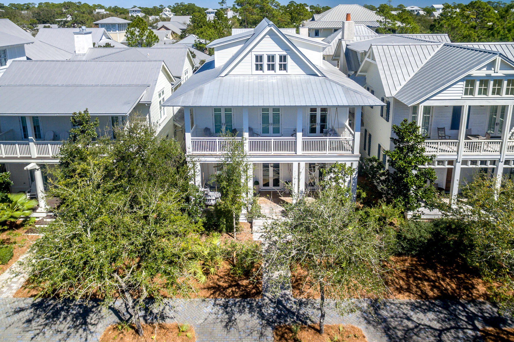 Sitting on Hwy 30-A in phase 1 of Watercolor, this house is in a prime location only blocks away from the Watercolor beach club pools and beach access. With  over 5,600 square feet and a very open concept floor plan, this house is ideal for entertaining. The main house has 5 bedrooms and 5.5 baths which includes 2 spacious master suites, one of which has its own private balcony over looking the scenic 30-A. The carriage house has 1 bedroom, 1 bathroom, and its own living/ kitchen area. It also has its own washer/dryer closet. When you are not out enjoying one of watercolors several amenities, this house has the ideal outdoor living space! The back porch area has a private heated swimming pool, grilling area, and a gorgeous outdoor Fireplace.